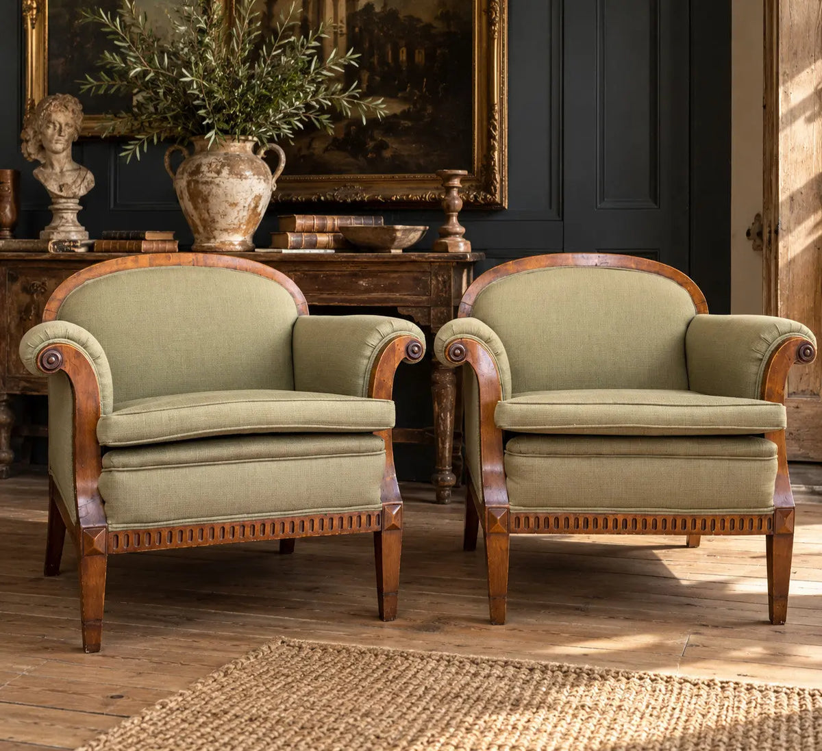 French's green Art Deco armchairs with walnut scroll arms and tapered legs.