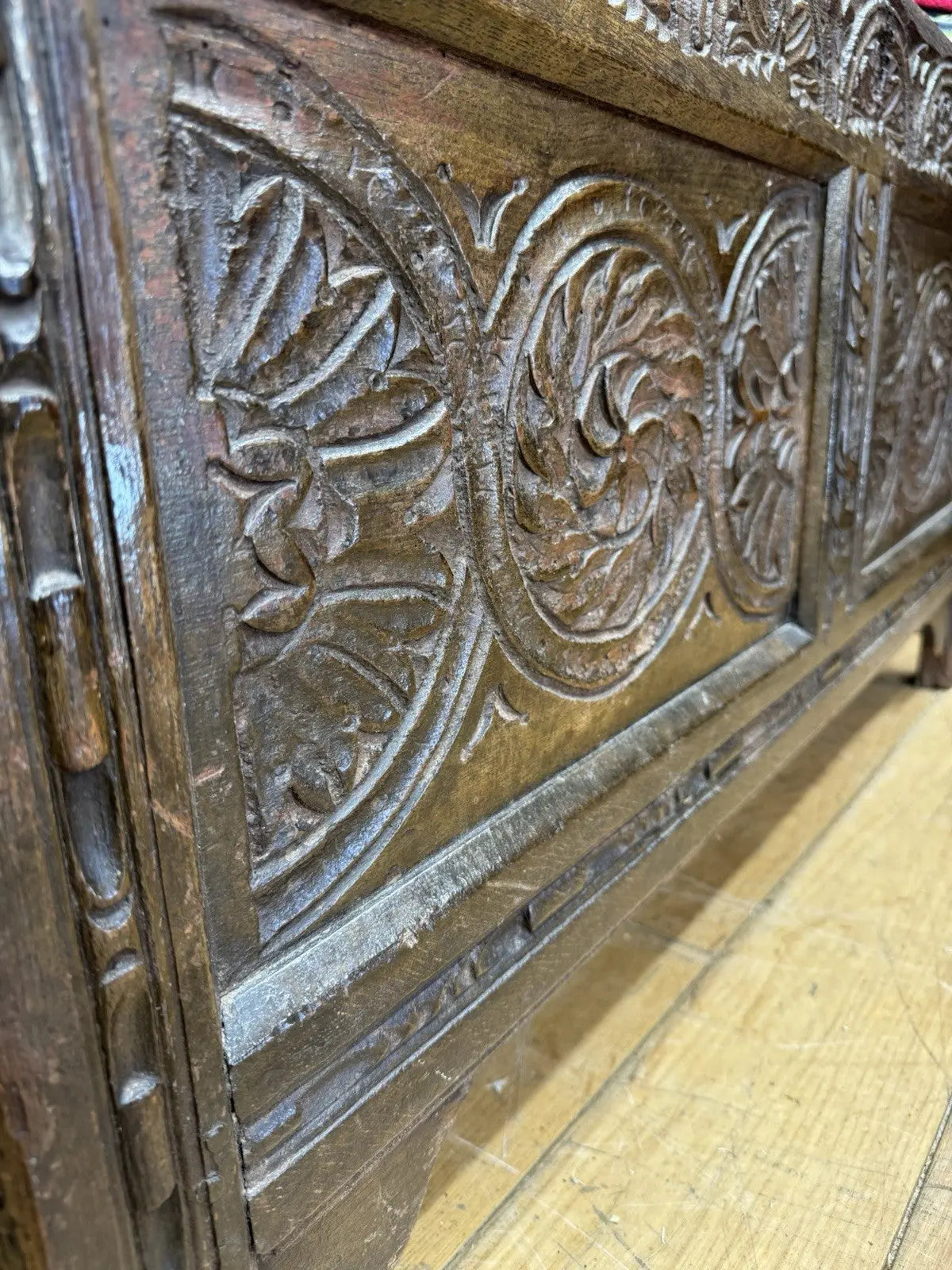 Antique oak hope chest brown with intricate floral carvings and spacious interior.