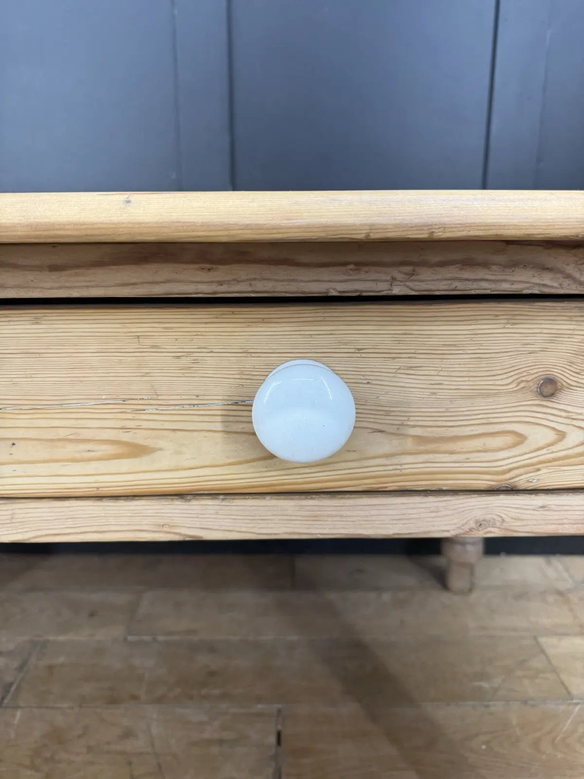 Victorian pine farmhouse dining table brown solid plank top with two drawers and ceramic knobs.