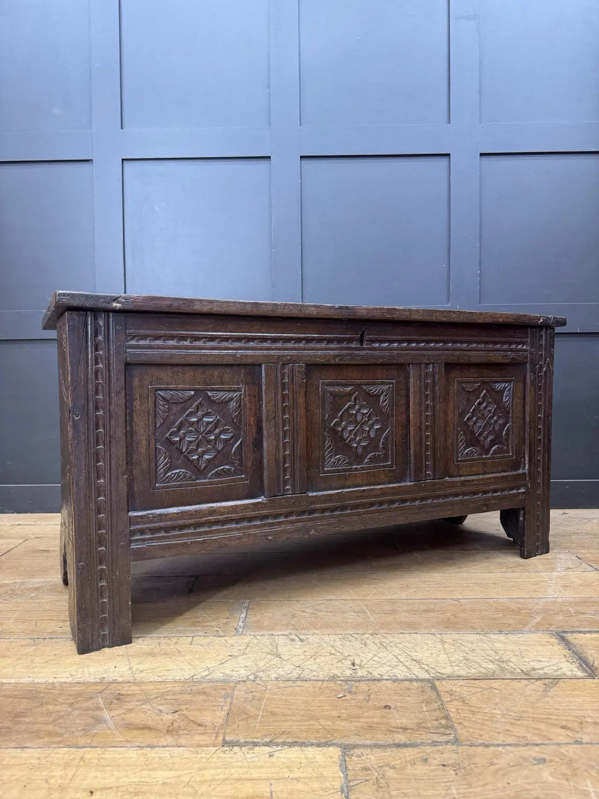 Georgian carved oak hope chest brown with floral motifs and iron hinges.