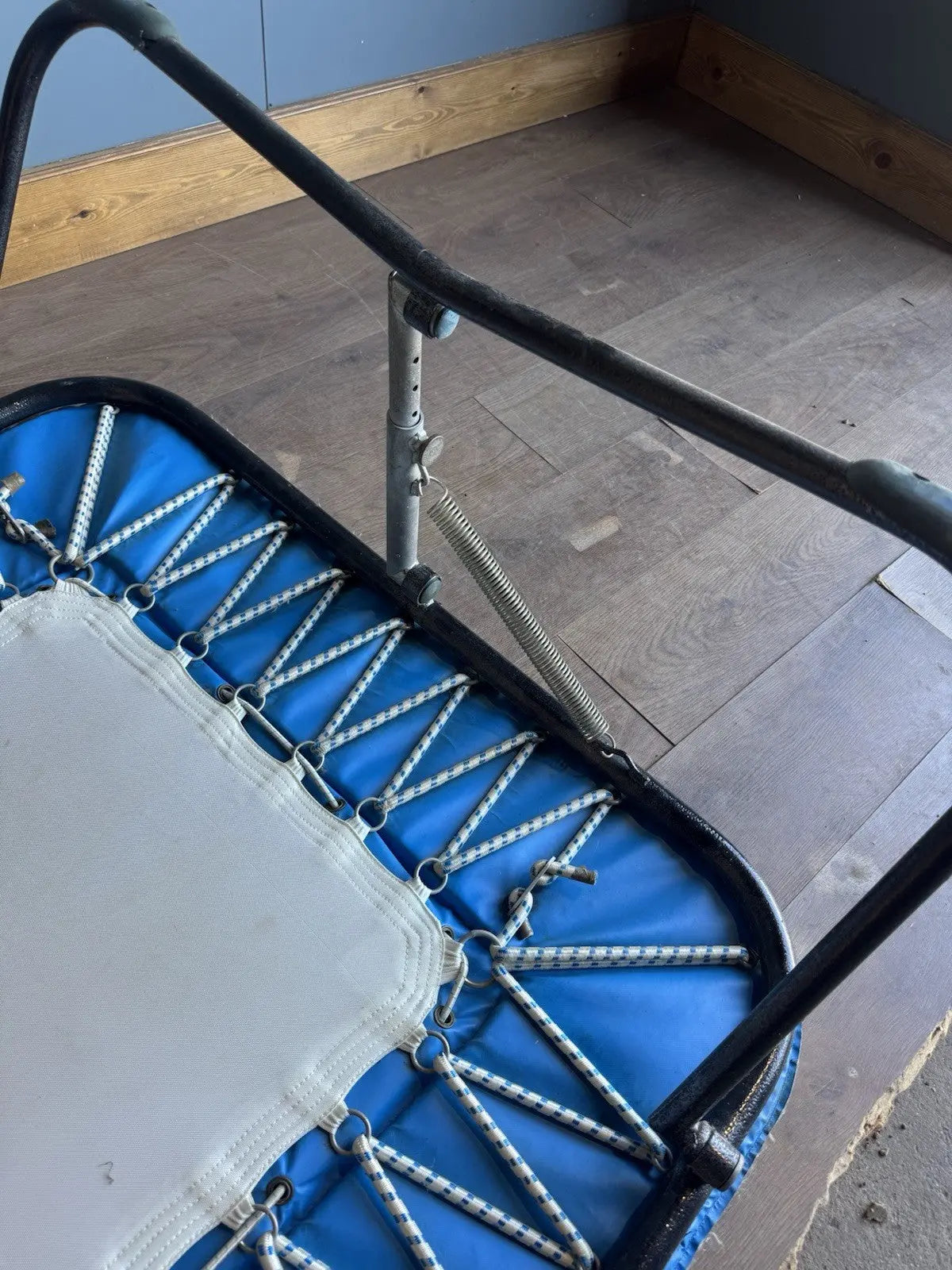 Rebounder black and blue gymnastics trampette with Nissen International logo and woven jumping bed.