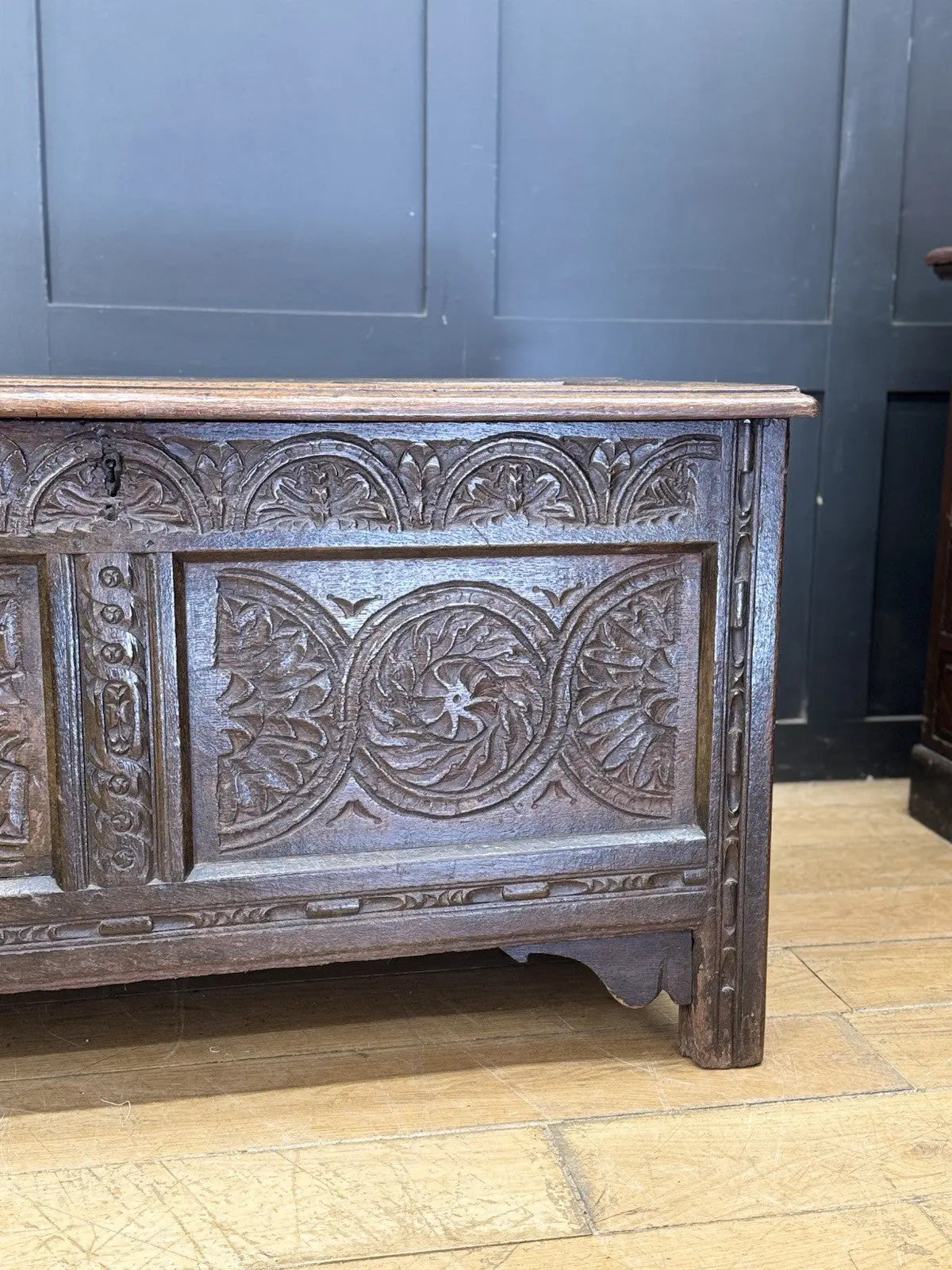 Antique oak hope chest brown with intricate floral carvings and spacious interior.