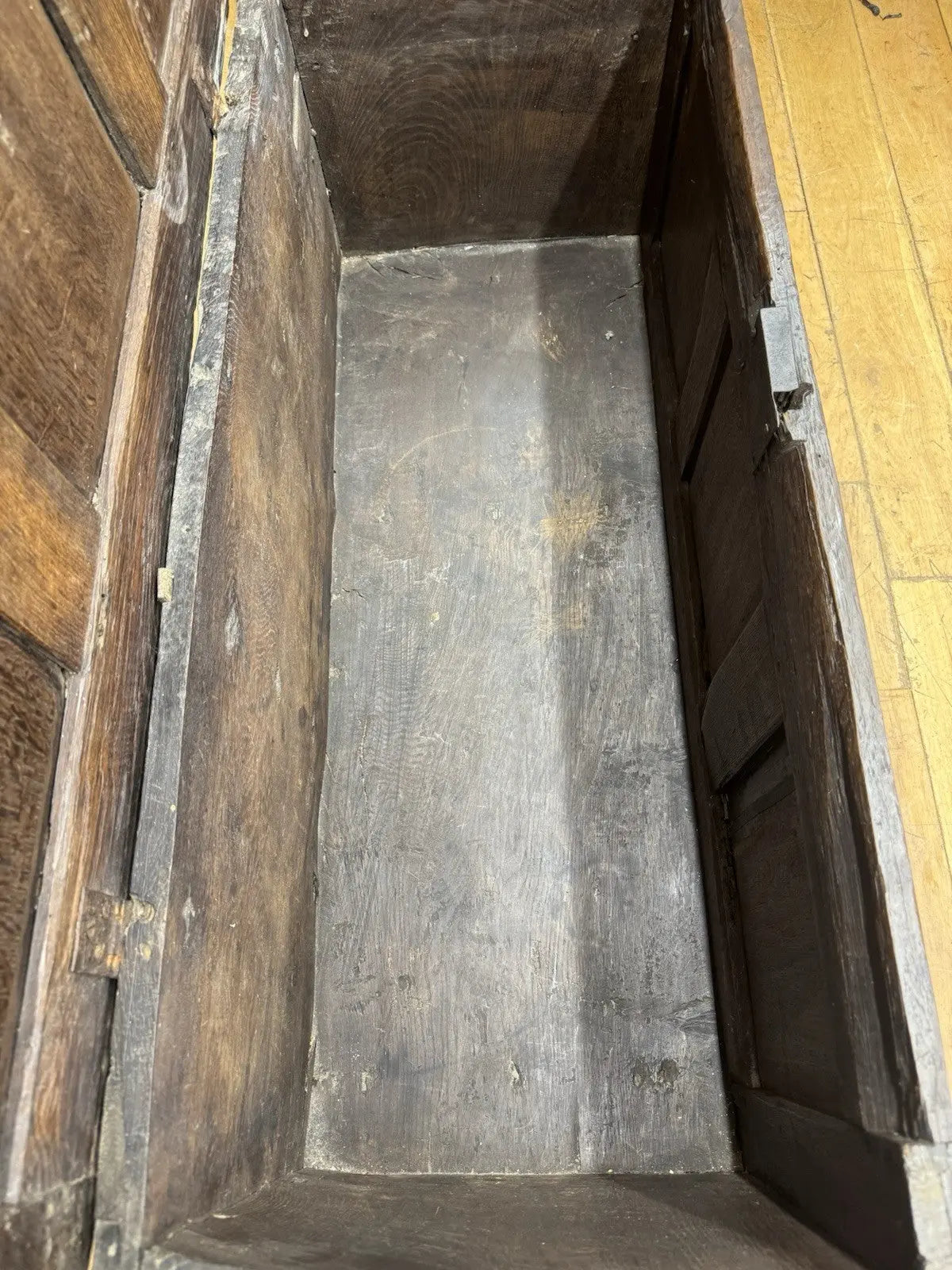 Georgian carved oak hope chest brown with floral motifs and iron hinges.