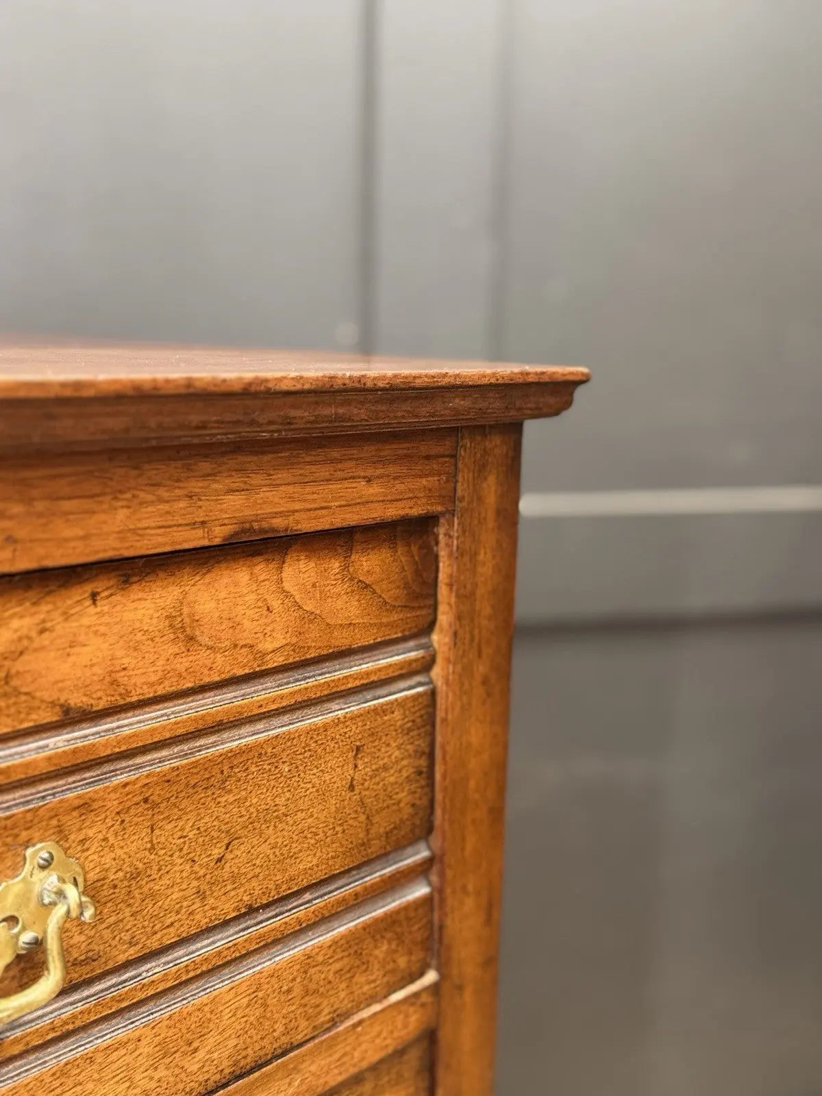 Edwardian brown dresser with three long drawers, decorative brass handles and attractive wood figuring.