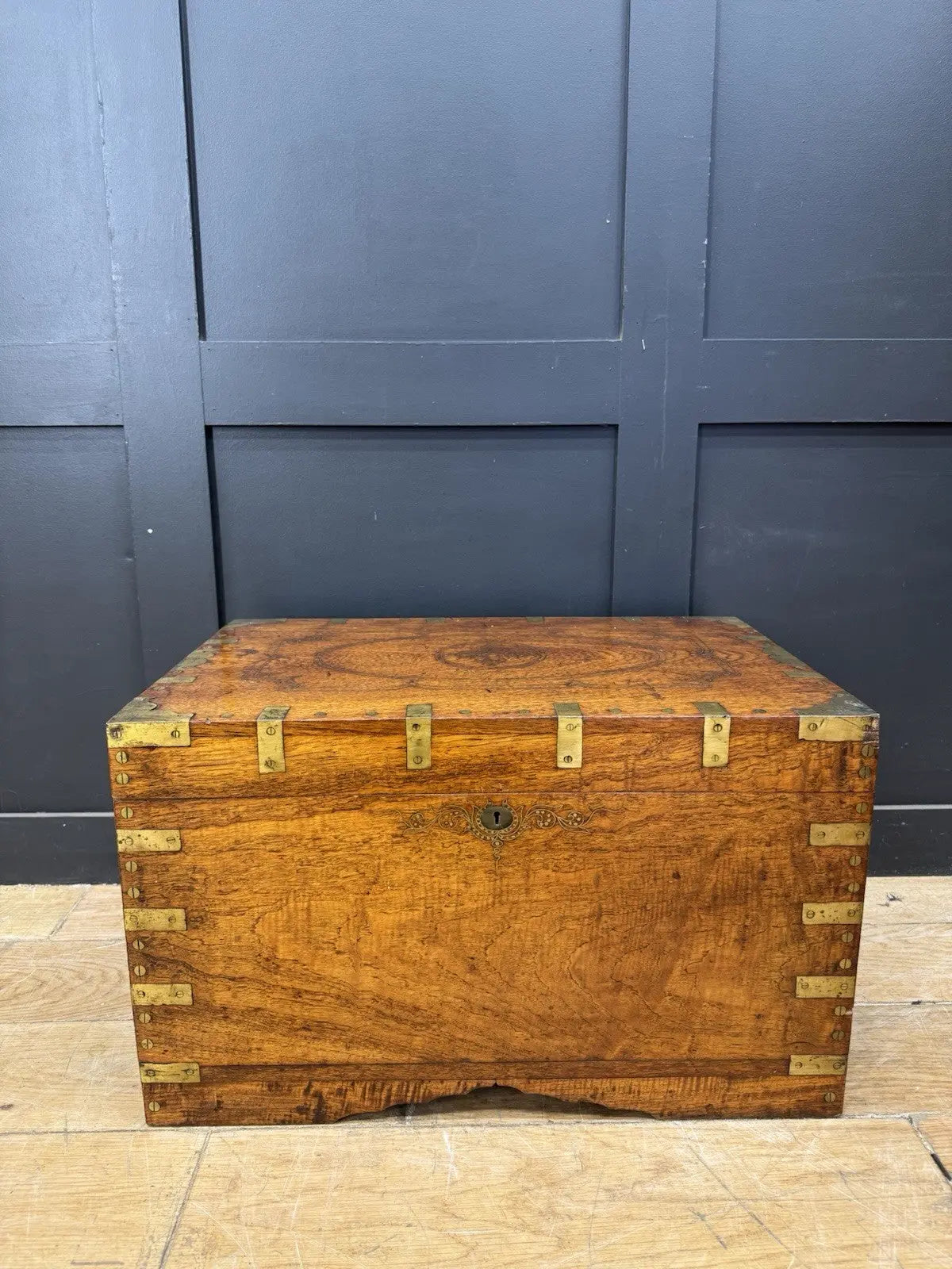 Antique Anglo-Burmese teak campaign chest trunk with brass strapwork and drop-handle.