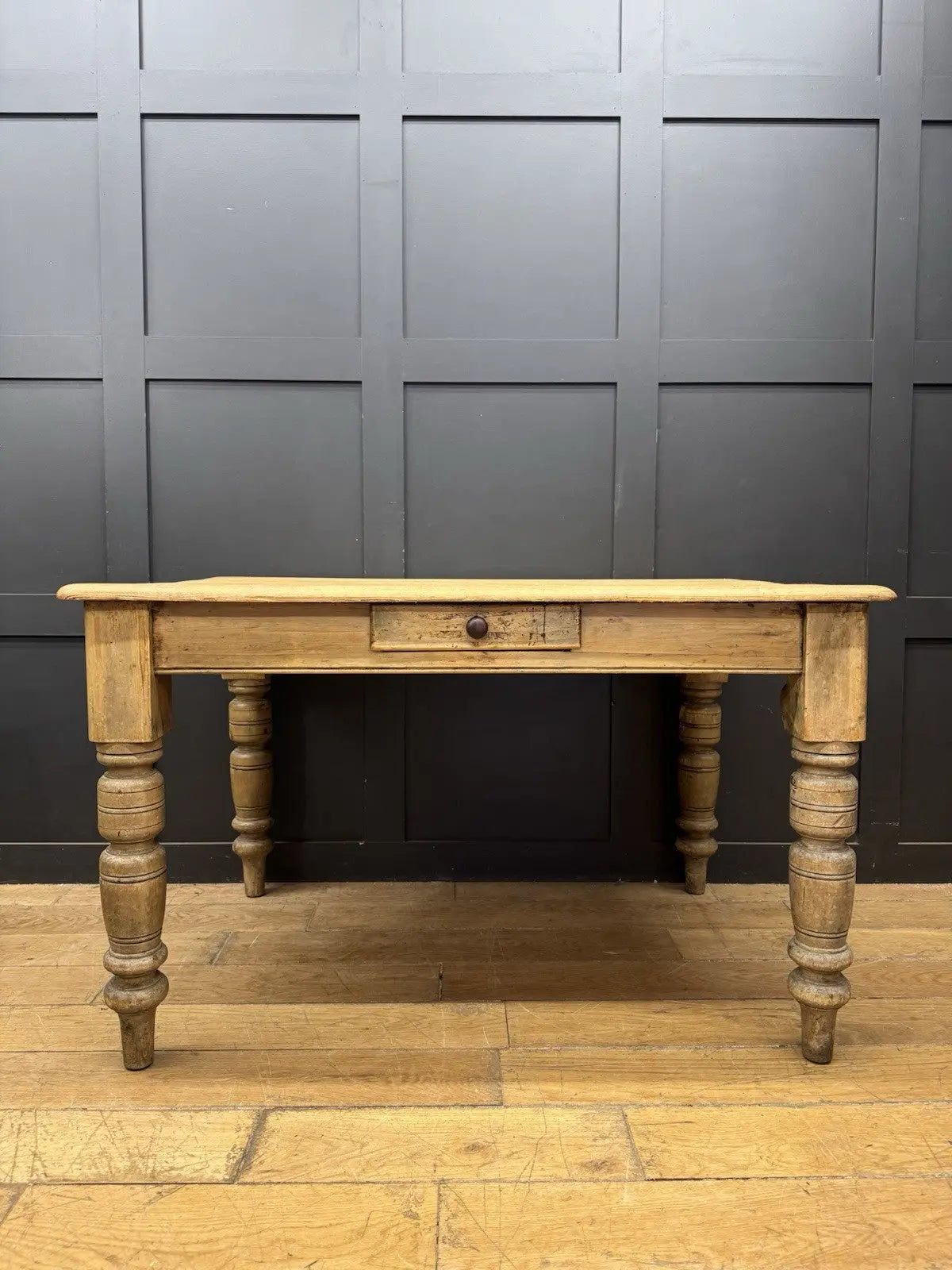 Late Victorian farmhouse kitchen table, scrubbed pine, ring-turned legs, single drawer, timeworn surface.
