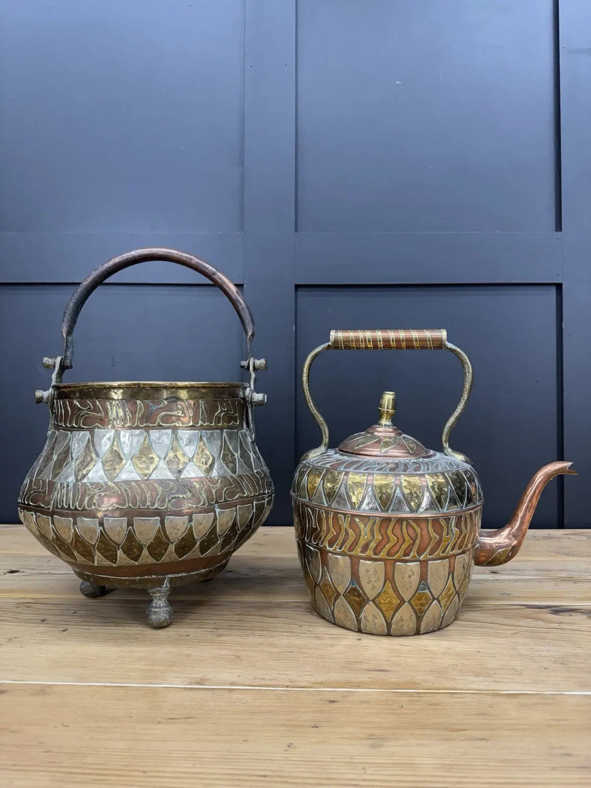 Antique Moroccan copper tea kettle and brass cauldron planter with ornate geometric patterns.