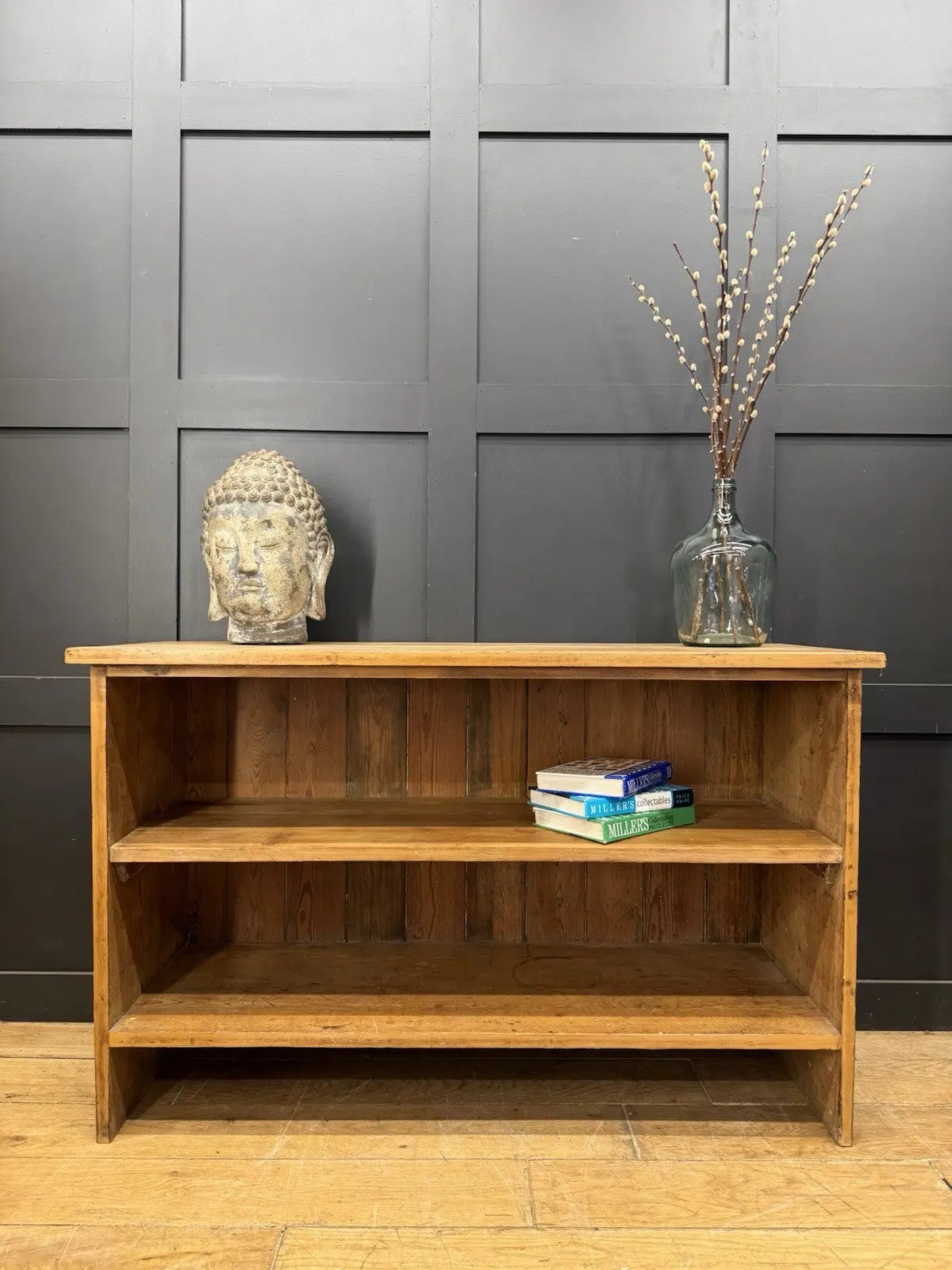 Vintage pine bookcase with warm, aged finish and two open shelves.