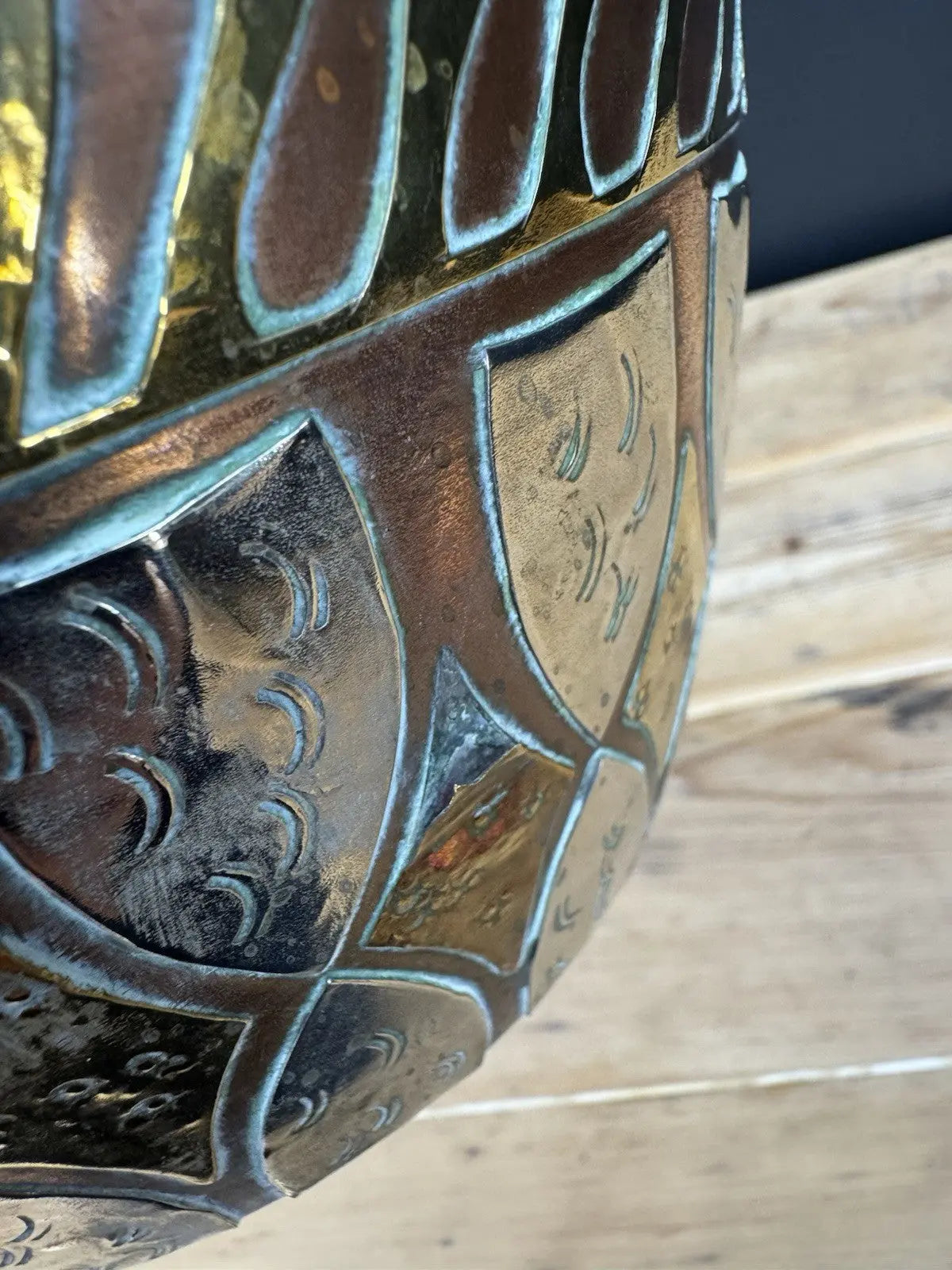 Antique Moroccan copper tea kettle and brass cauldron planter with ornate geometric patterns.