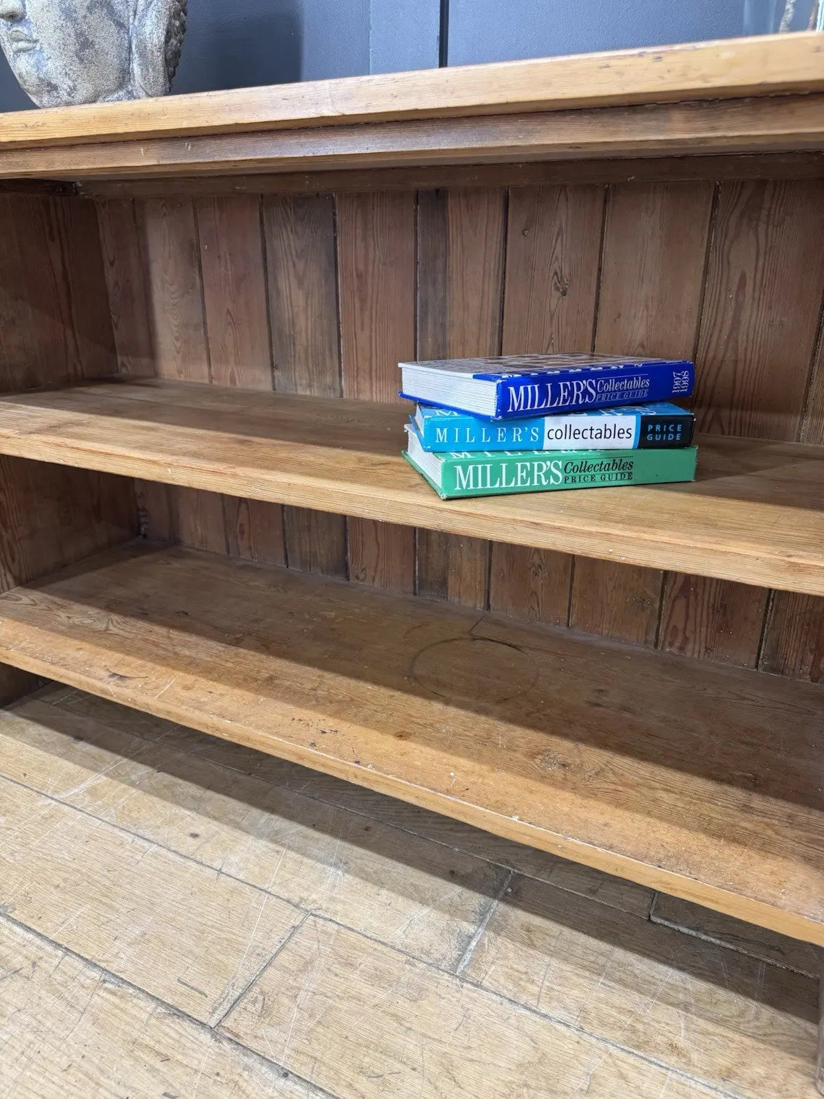 Vintage pine bookcase with warm, aged finish and two open shelves.
