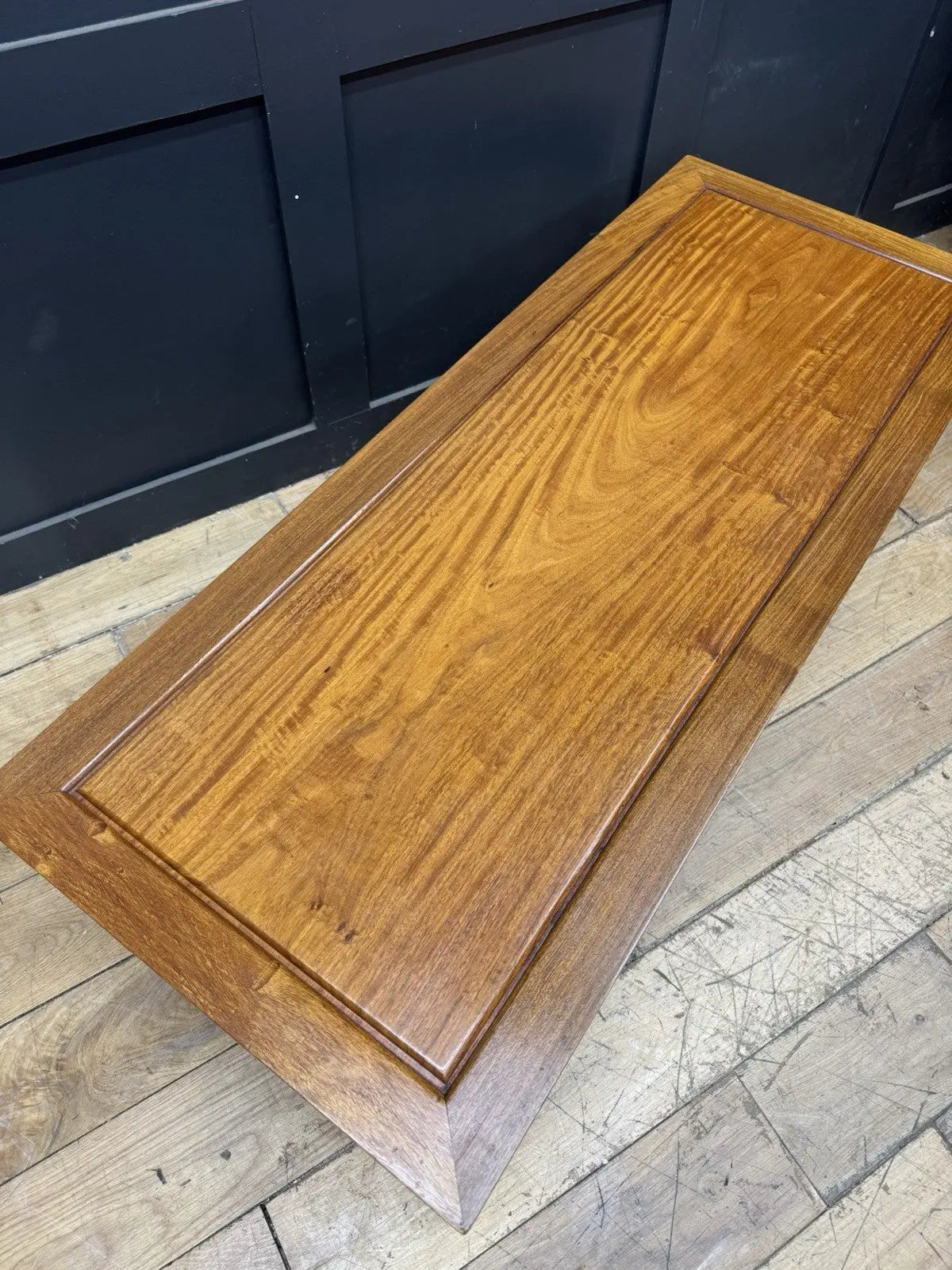 Contemporary Chinese hardwood coffee table brown rectangular top with framed construction and square legs.