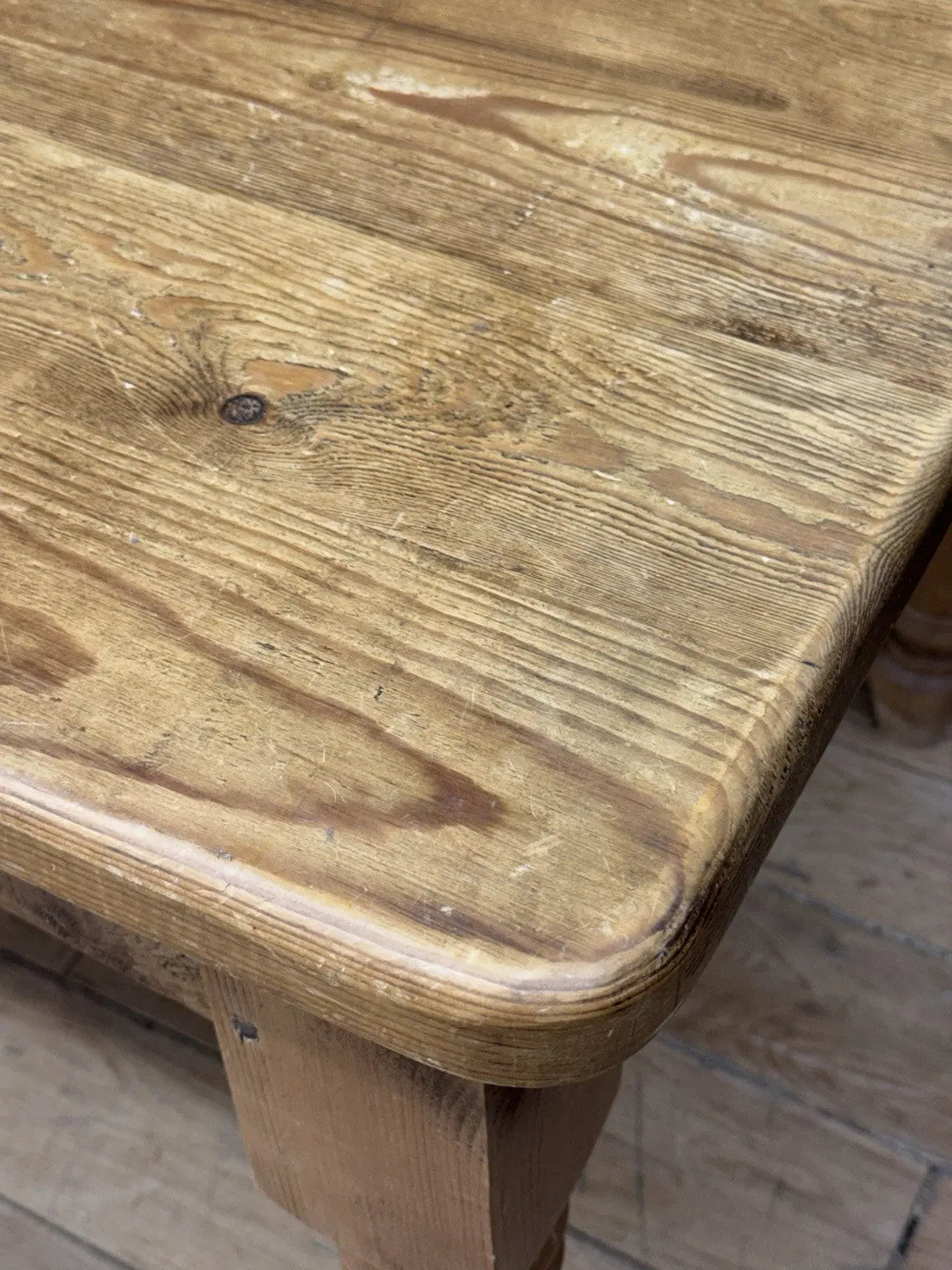 Pine farmhouse dining table brown rectangular top with turned legs and natural grain.