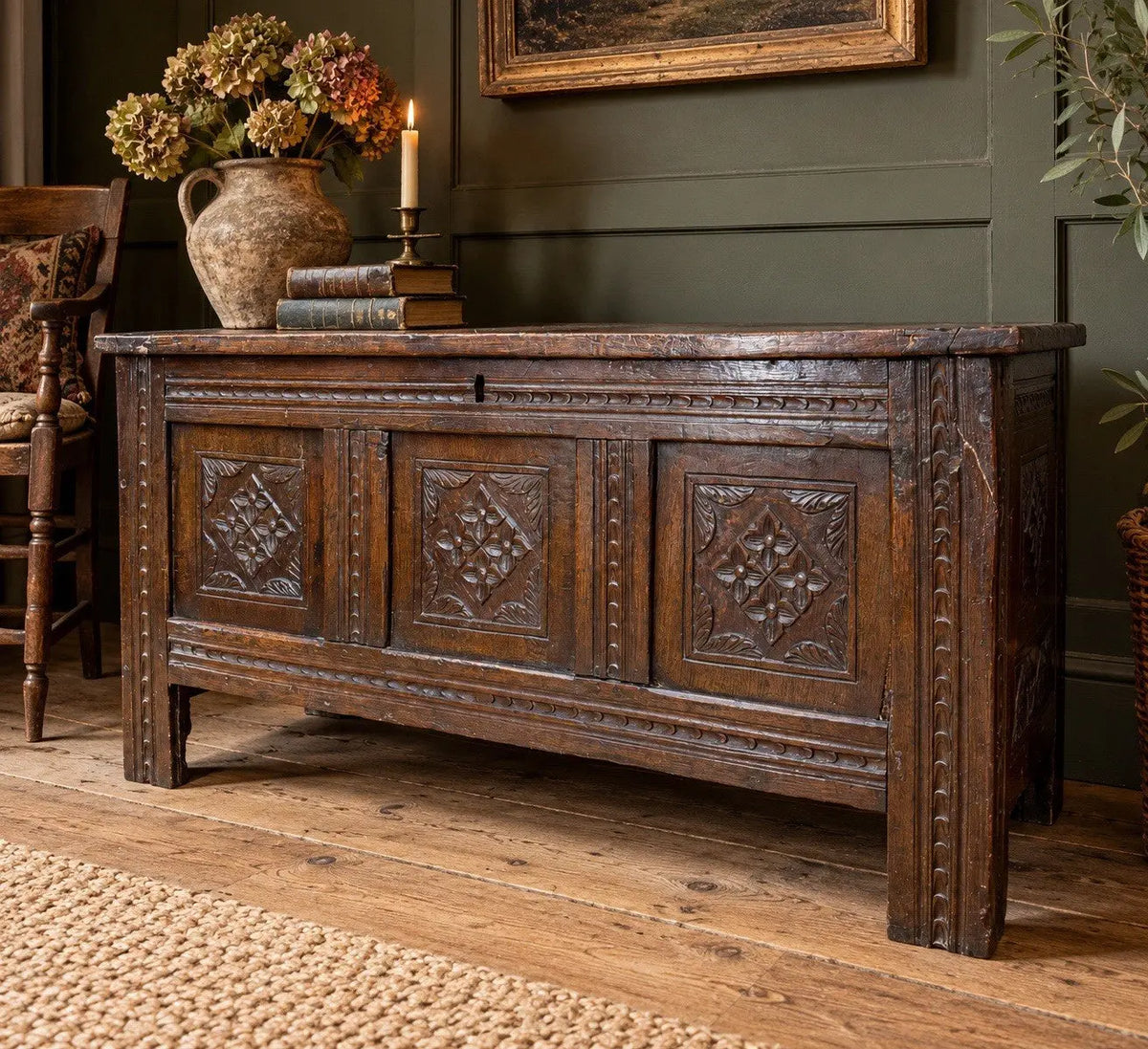 Georgian carved oak hope chest brown with floral motifs and iron hinges.
