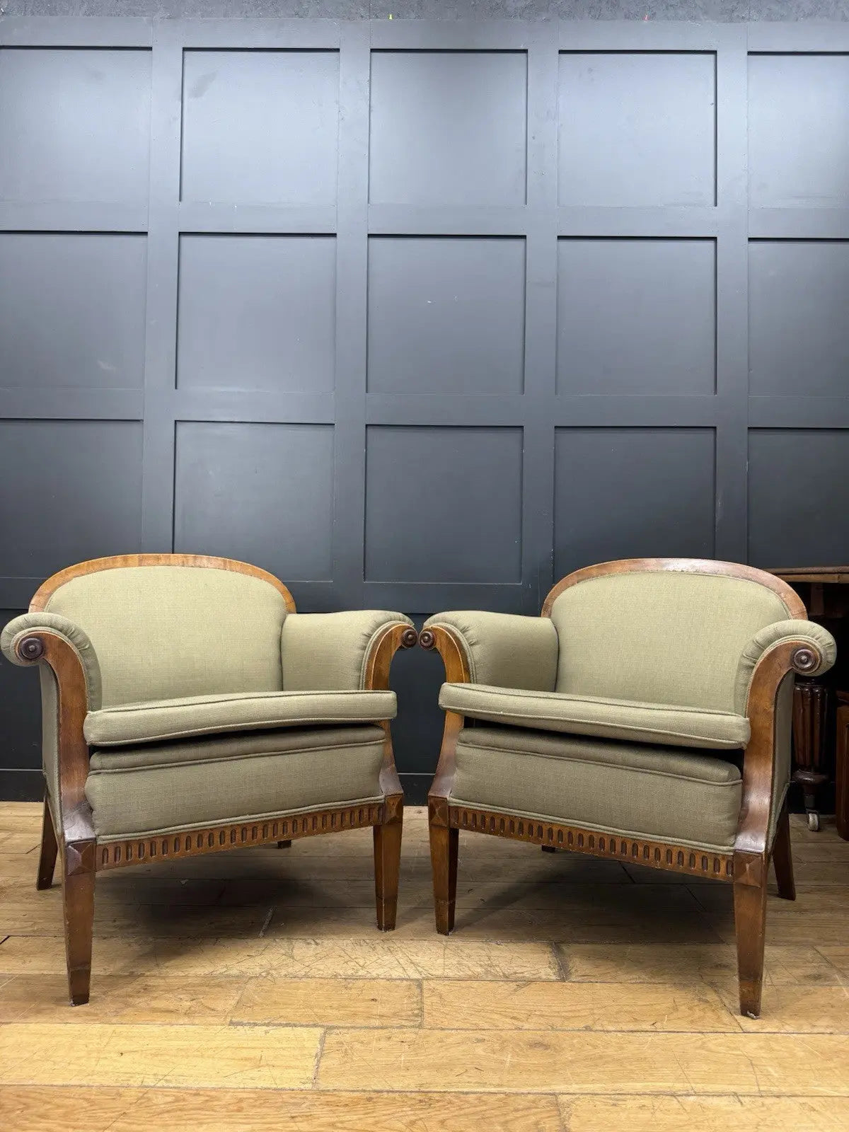 French's green Art Deco armchairs with walnut scroll arms and tapered legs.