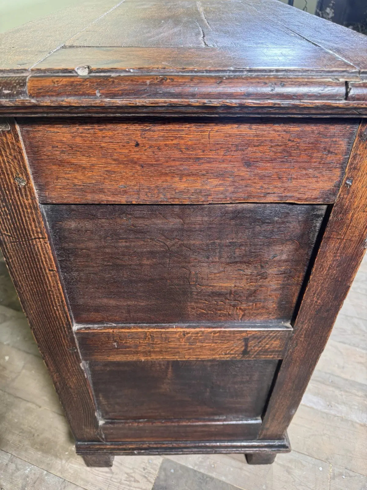Antique oak mule chest brown four-panelled design with two drawers and rich grain.