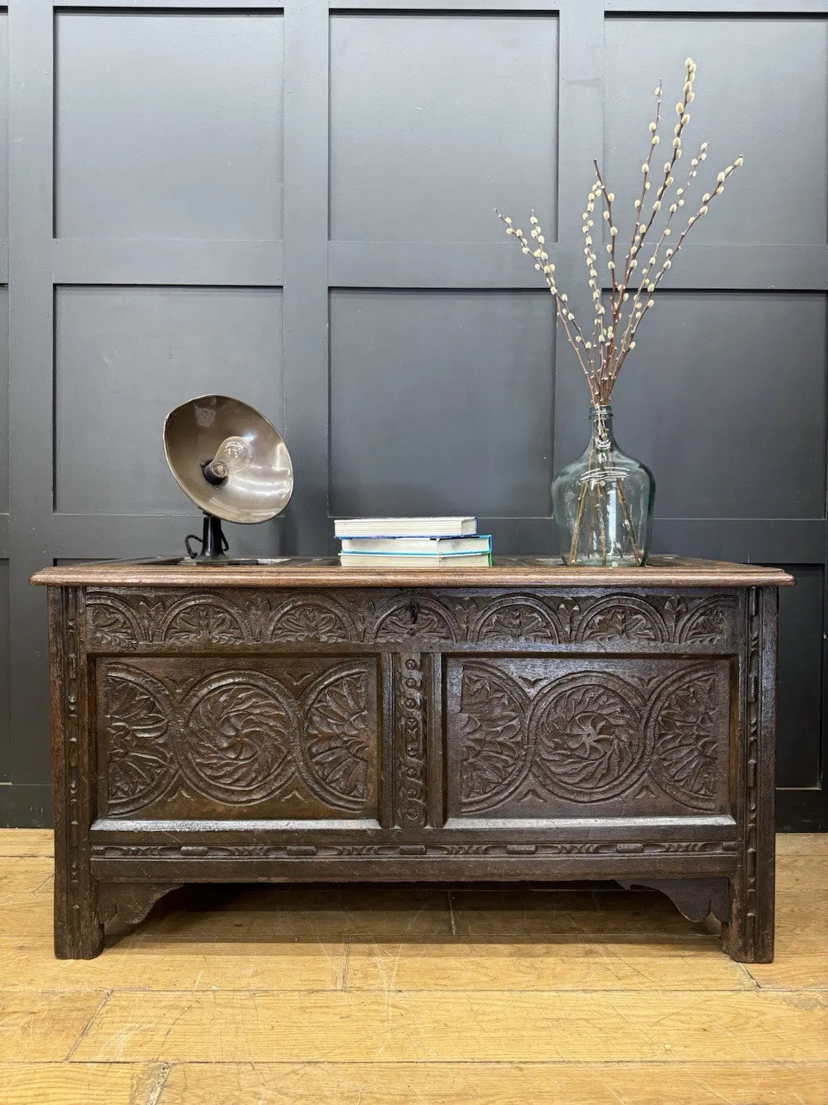 Antique oak hope chest brown with intricate floral carvings and spacious interior.