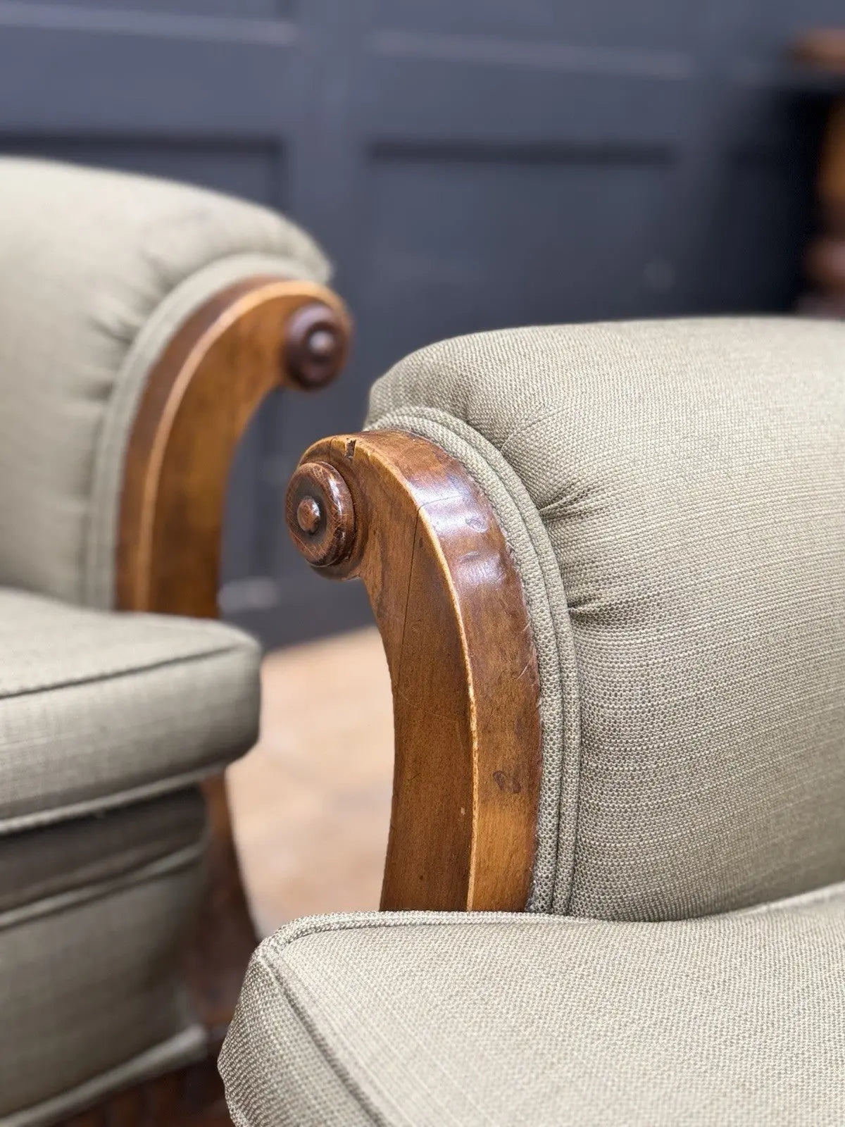 French's green Art Deco armchairs with walnut scroll arms and tapered legs.