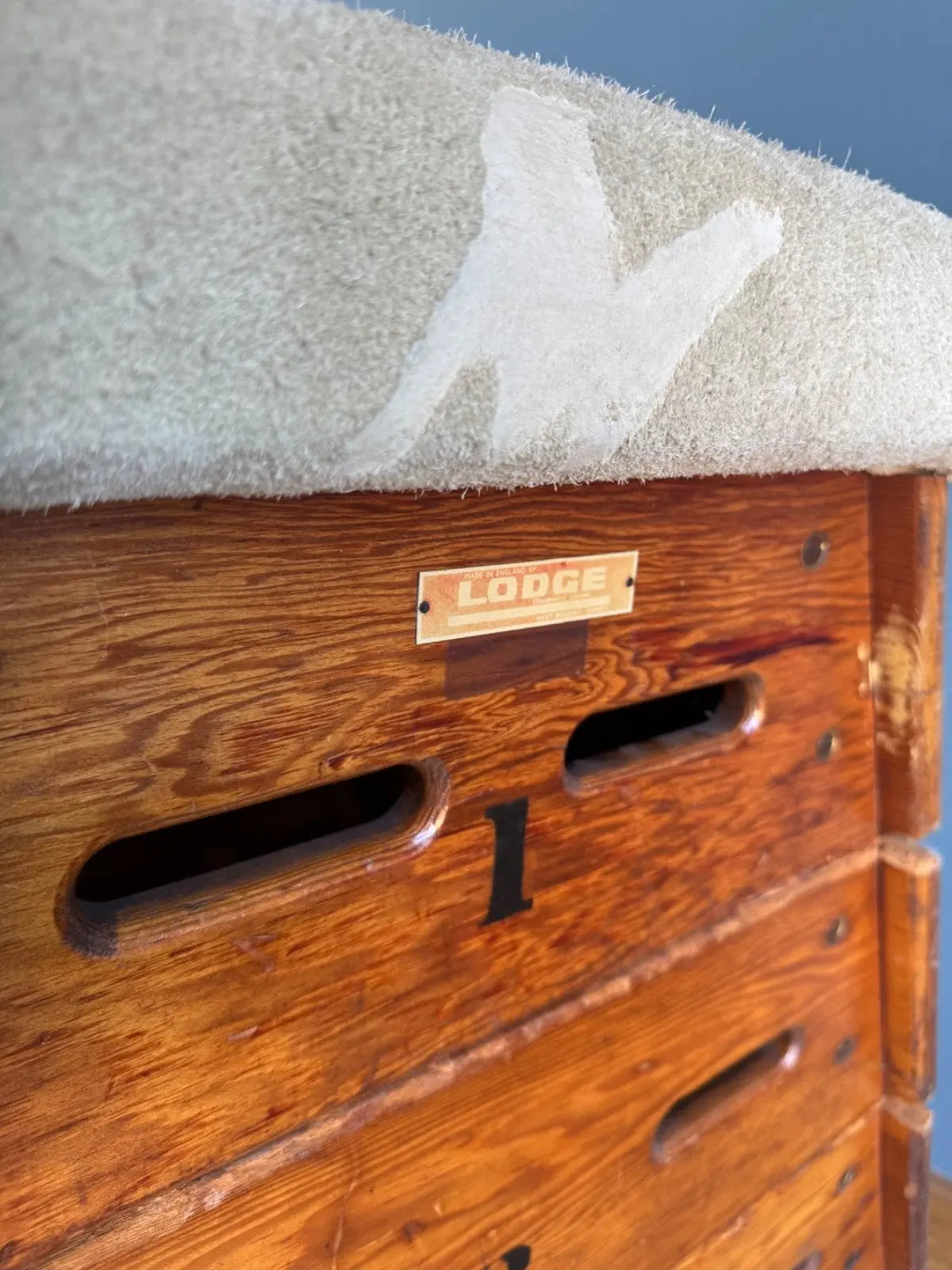 Lodge vintage wooden pommel horse with original maker's label, padded top, and worn patina.