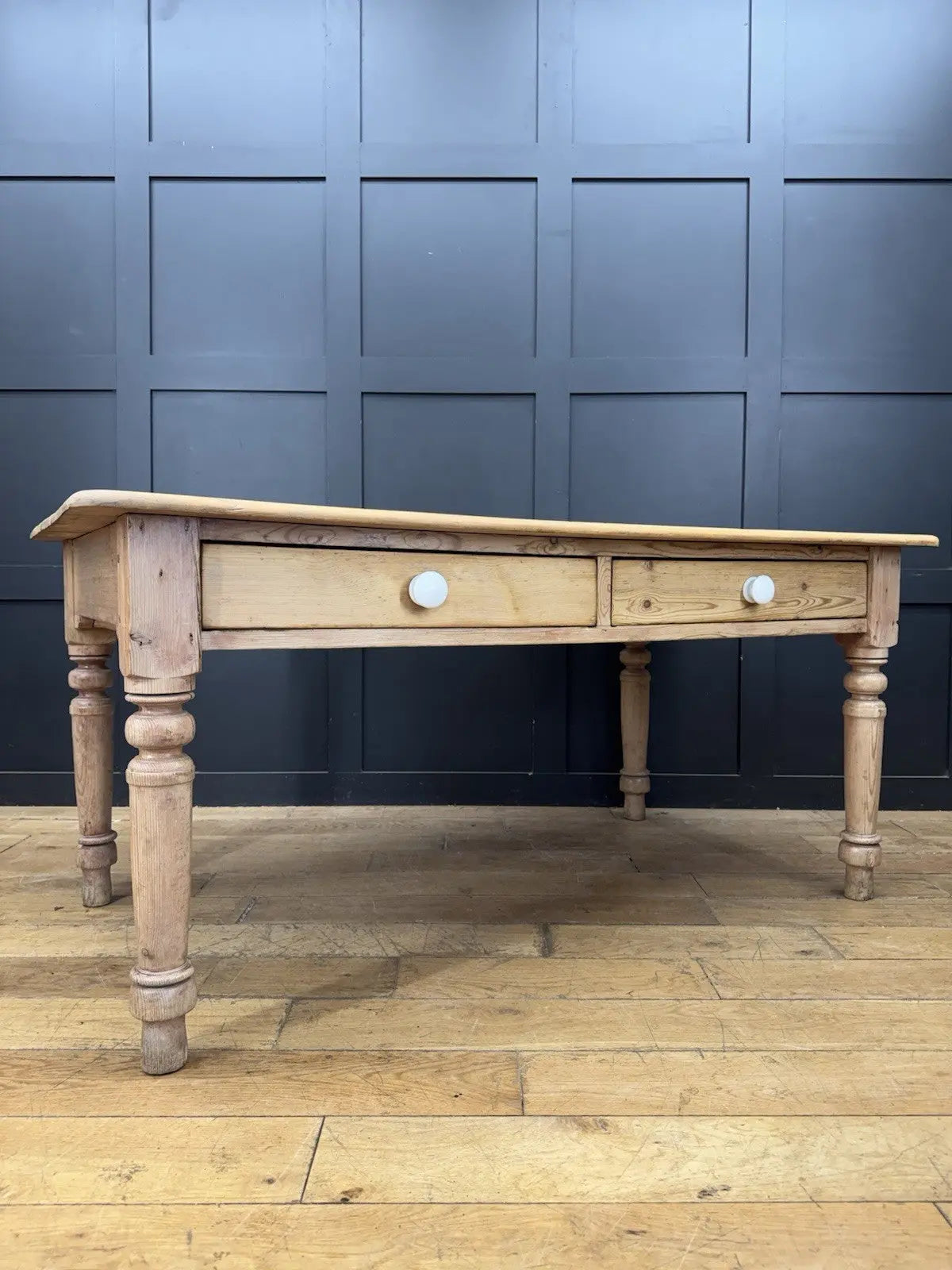 Victorian pine farmhouse dining table brown solid plank top with two drawers and ceramic knobs.