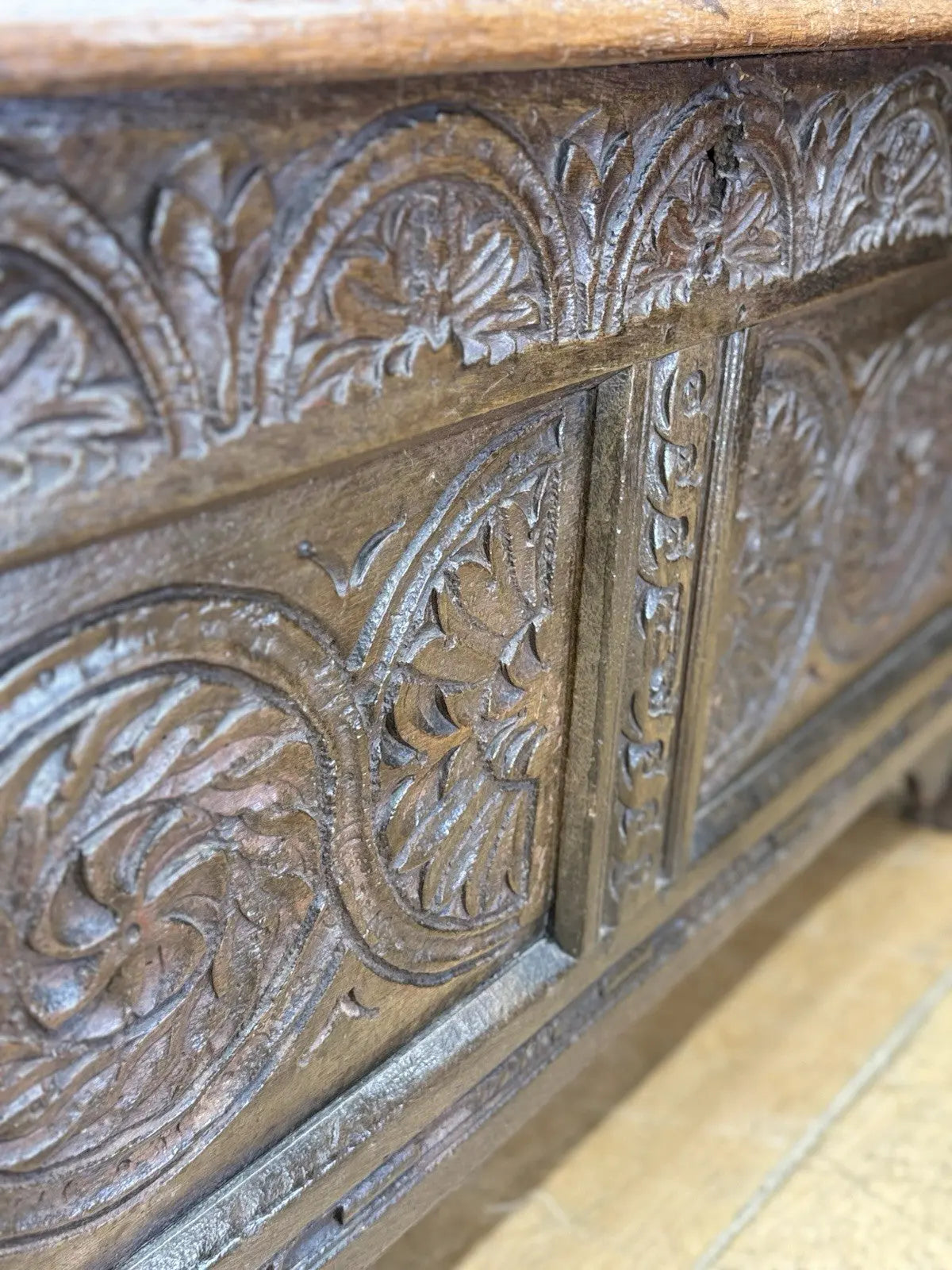 Antique oak hope chest brown with intricate floral carvings and spacious interior.