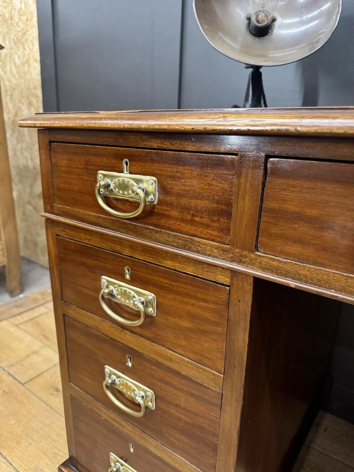 Victorian walnut writing desk brown with green leather top and brass drop handles.