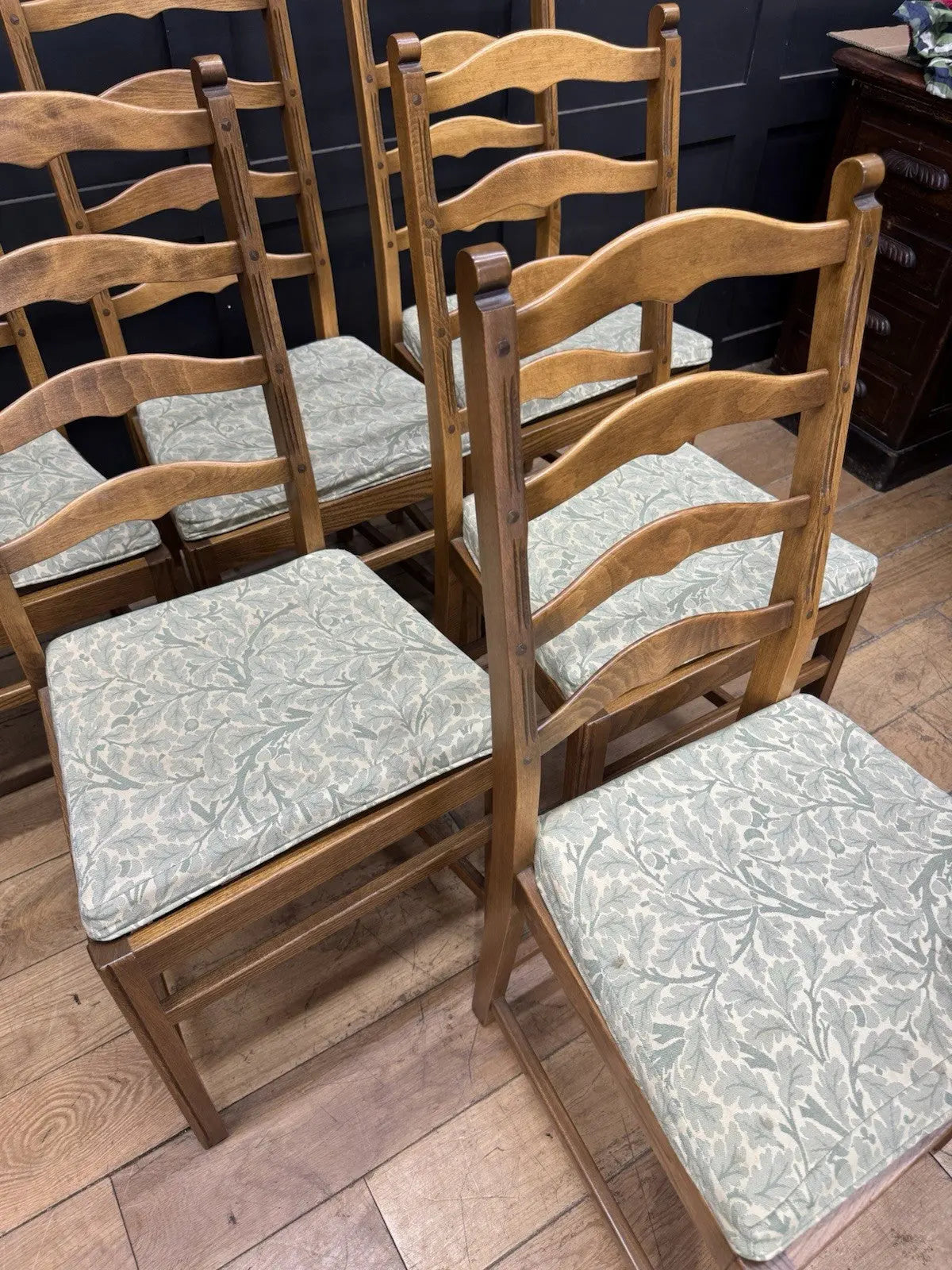 Ercol vintage ladderback dining chairs brown elm beech with green botanical patterned seat pads.