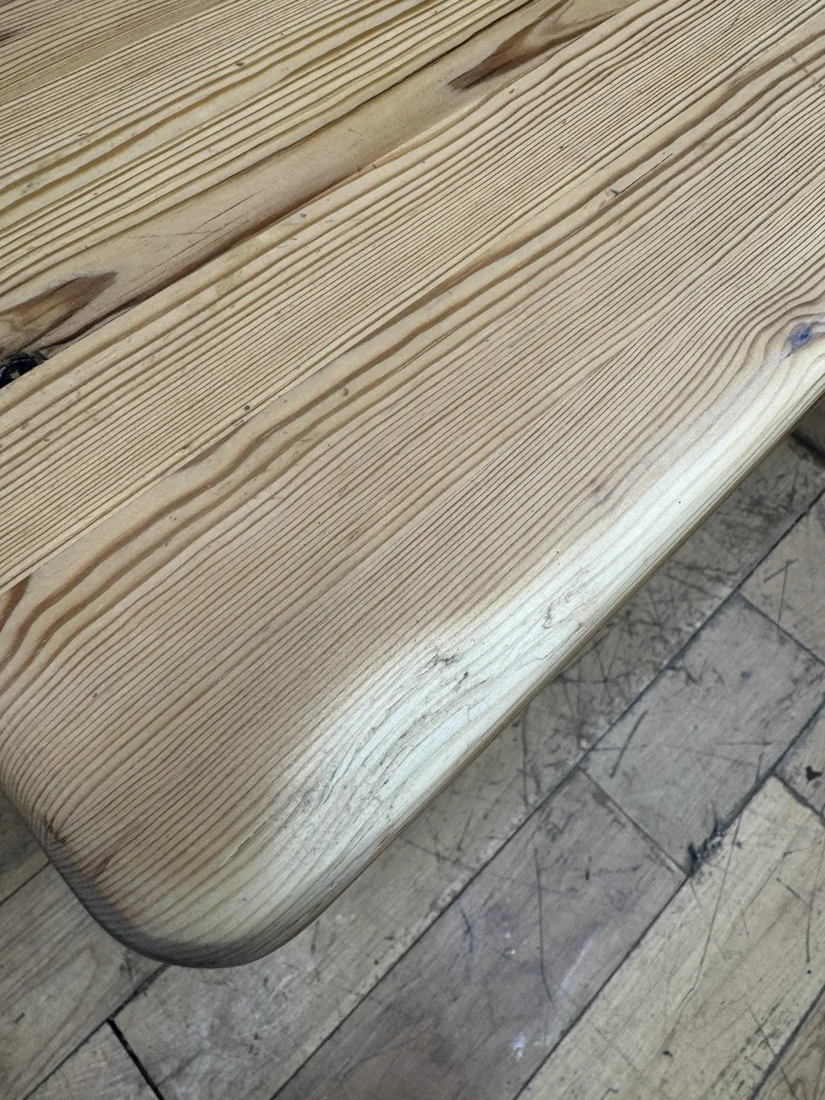 Vintage brown farmhouse dining table with turned legs and central drawer featuring white ceramic knob.