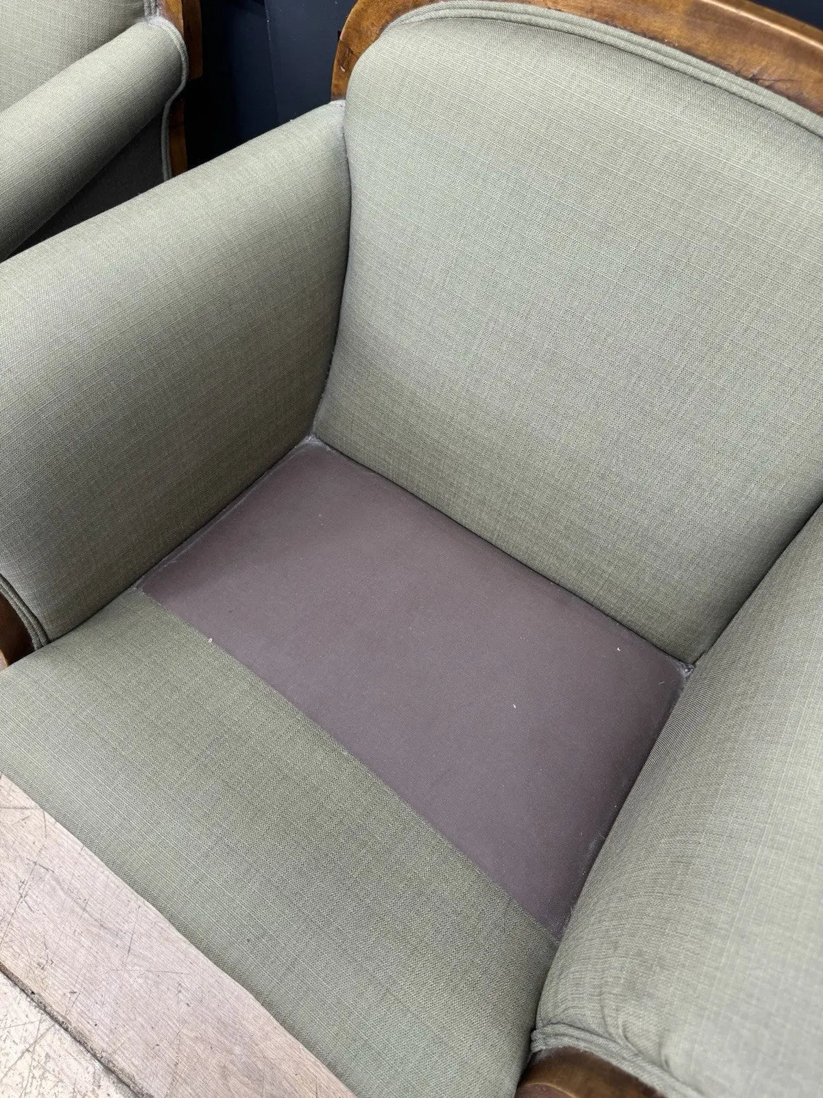 French's green Art Deco armchairs with walnut scroll arms and tapered legs.