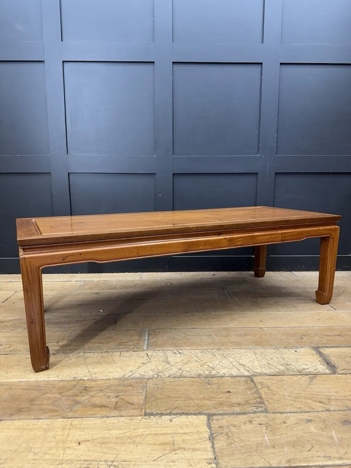 Contemporary Chinese hardwood coffee table brown rectangular top with framed construction and square legs.