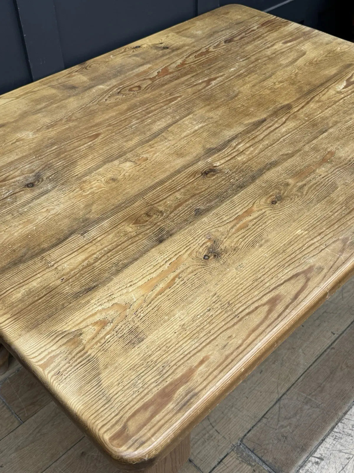 Pine farmhouse dining table brown rectangular top with turned legs and natural grain.