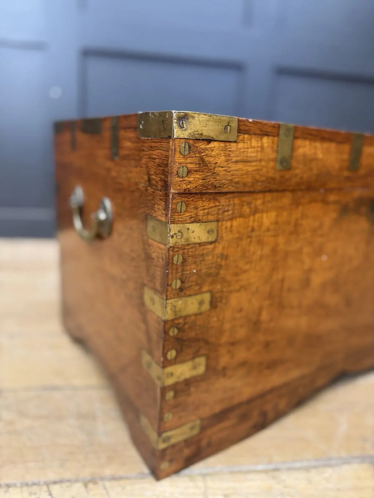 Antique Anglo-Burmese teak campaign chest trunk with brass strapwork and drop-handle.
