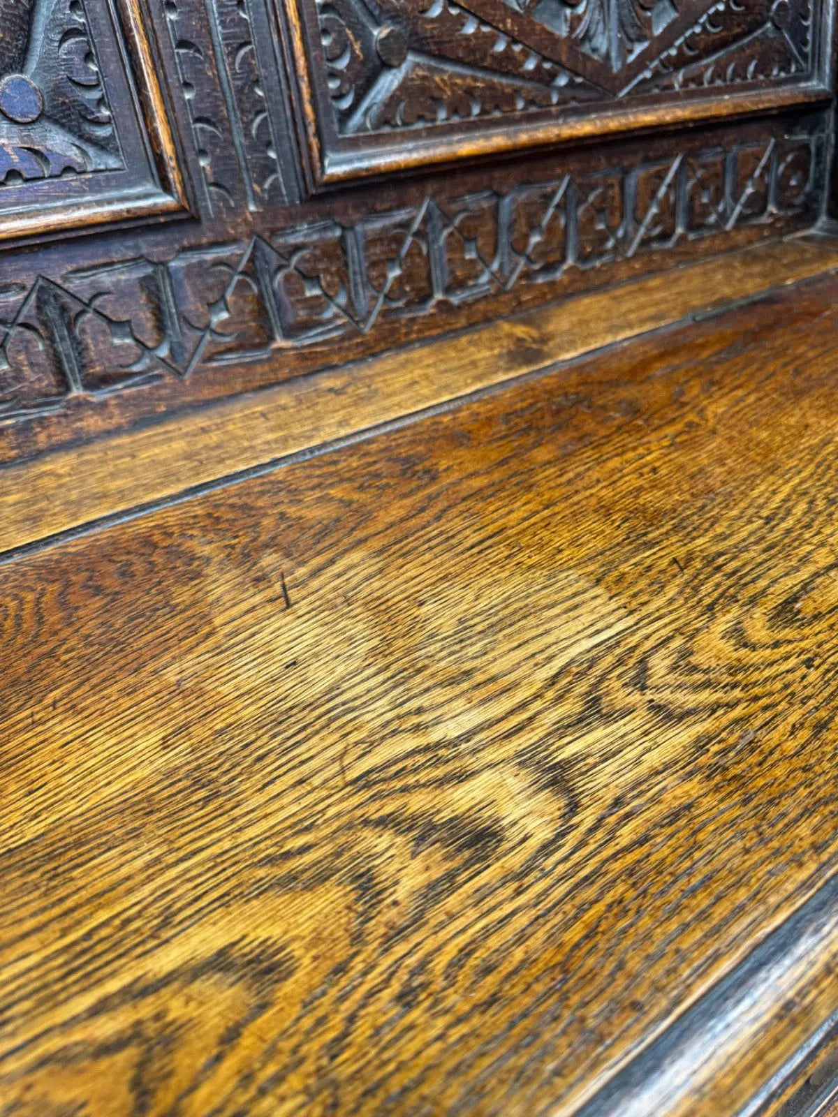 Victorian carved oak hall bench, brown, intricate Gothic Revival carvings and mythical figures.