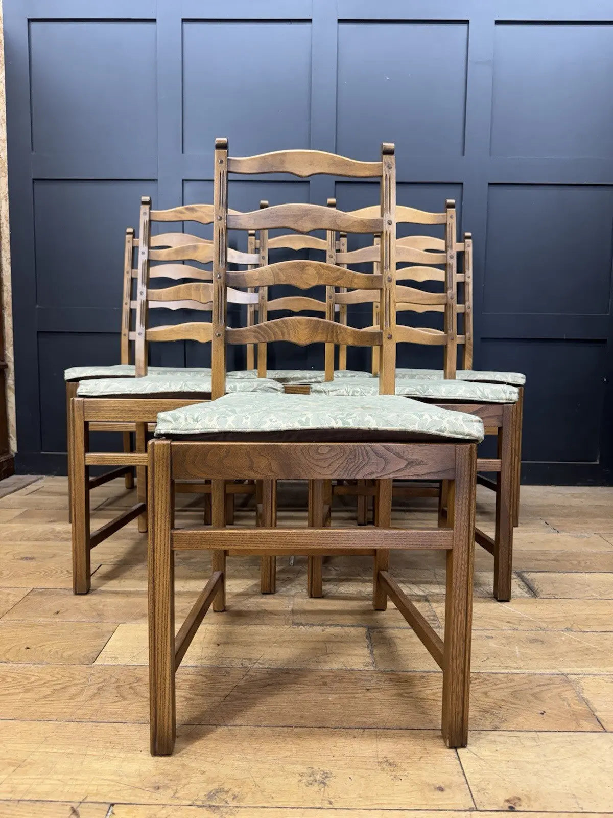 Ercol vintage ladderback dining chairs brown elm beech with green botanical patterned seat pads.