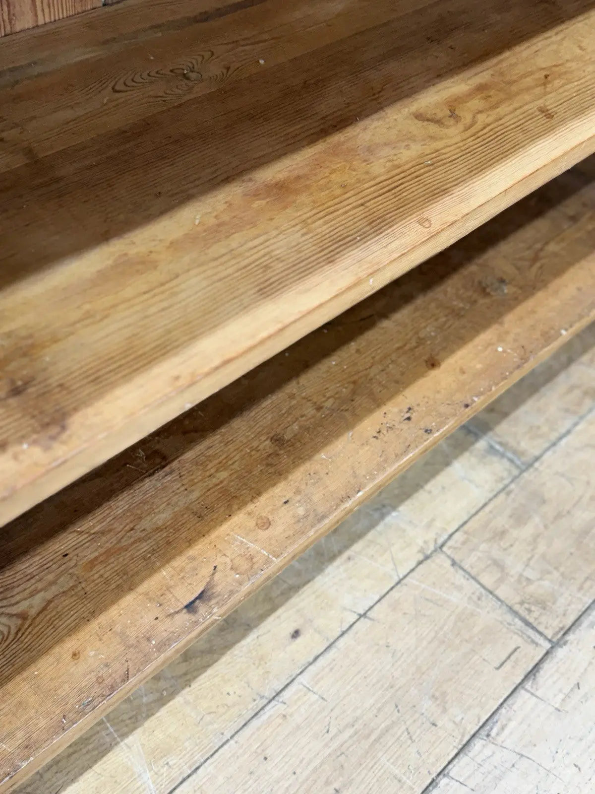 Vintage pine bookcase with warm, aged finish and two open shelves.
