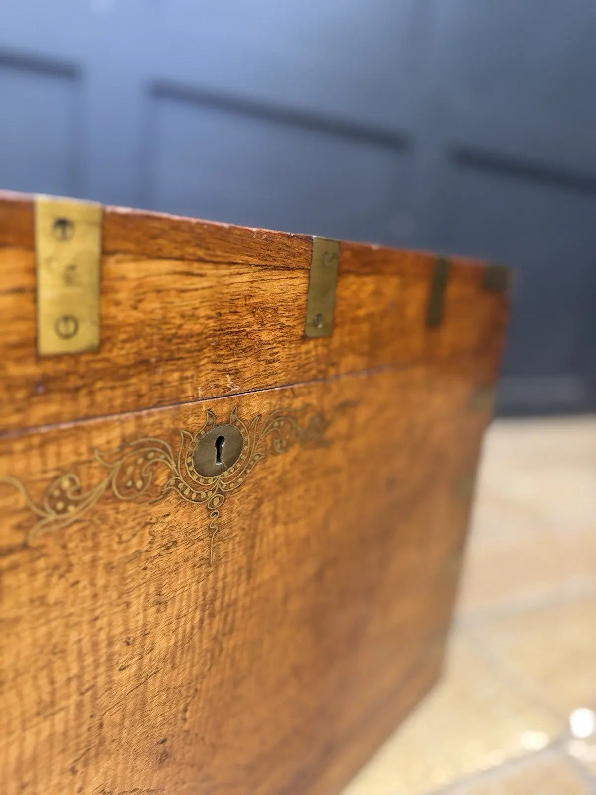 Antique Anglo-Burmese teak campaign chest trunk with brass strapwork and drop-handle.