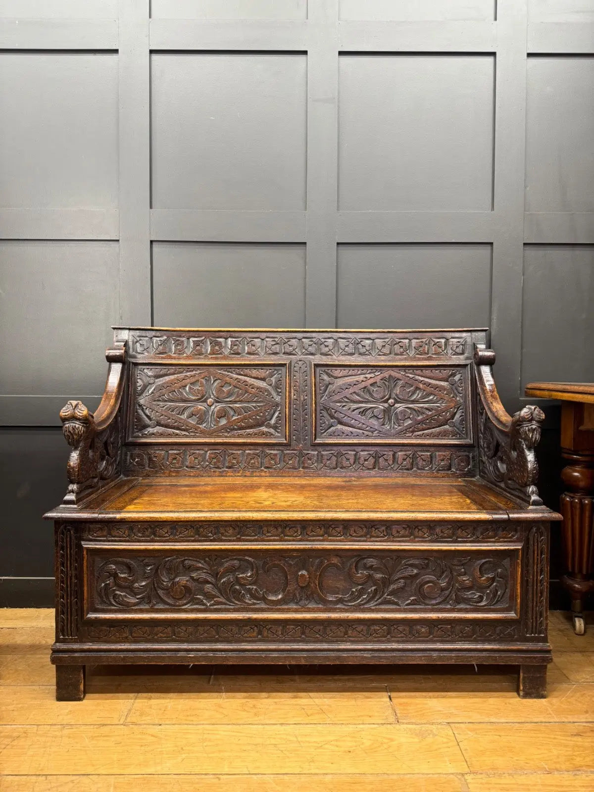 Victorian carved oak hall bench, brown, intricate Gothic Revival carvings and mythical figures.