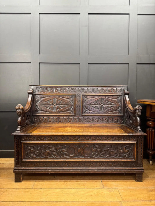 Victorian carved oak hall bench, brown, intricate Gothic Revival carvings and mythical figures.