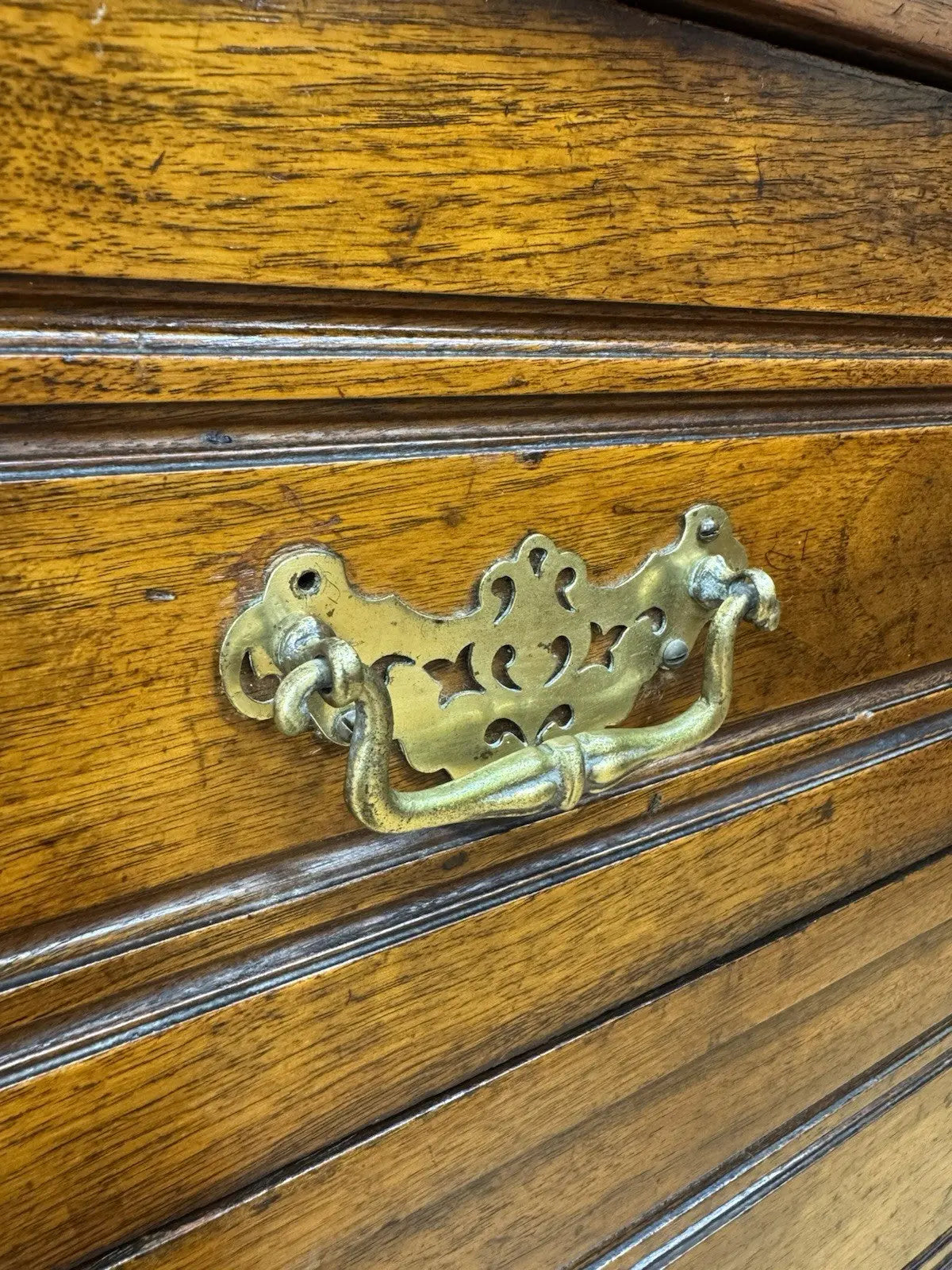 Edwardian brown dresser with three long drawers, decorative brass handles and attractive wood figuring.