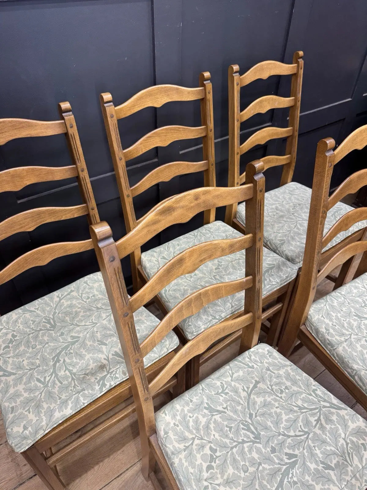 Ercol vintage ladderback dining chairs brown elm beech with green botanical patterned seat pads.