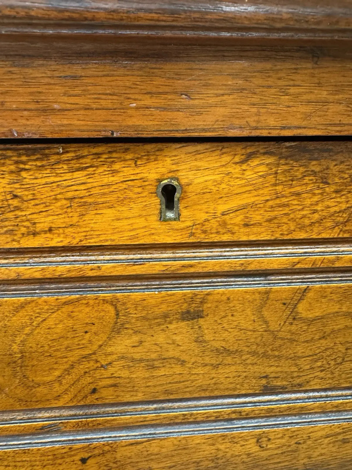 Edwardian brown dresser with three long drawers, decorative brass handles and attractive wood figuring.
