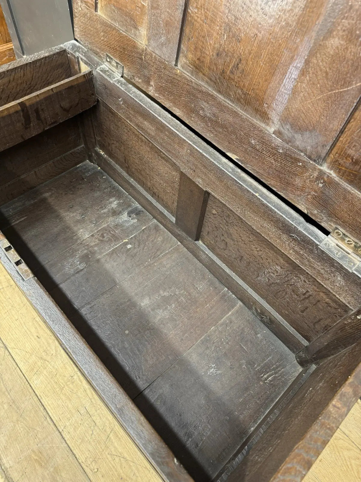 Antique oak hope chest brown with intricate floral carvings and spacious interior.