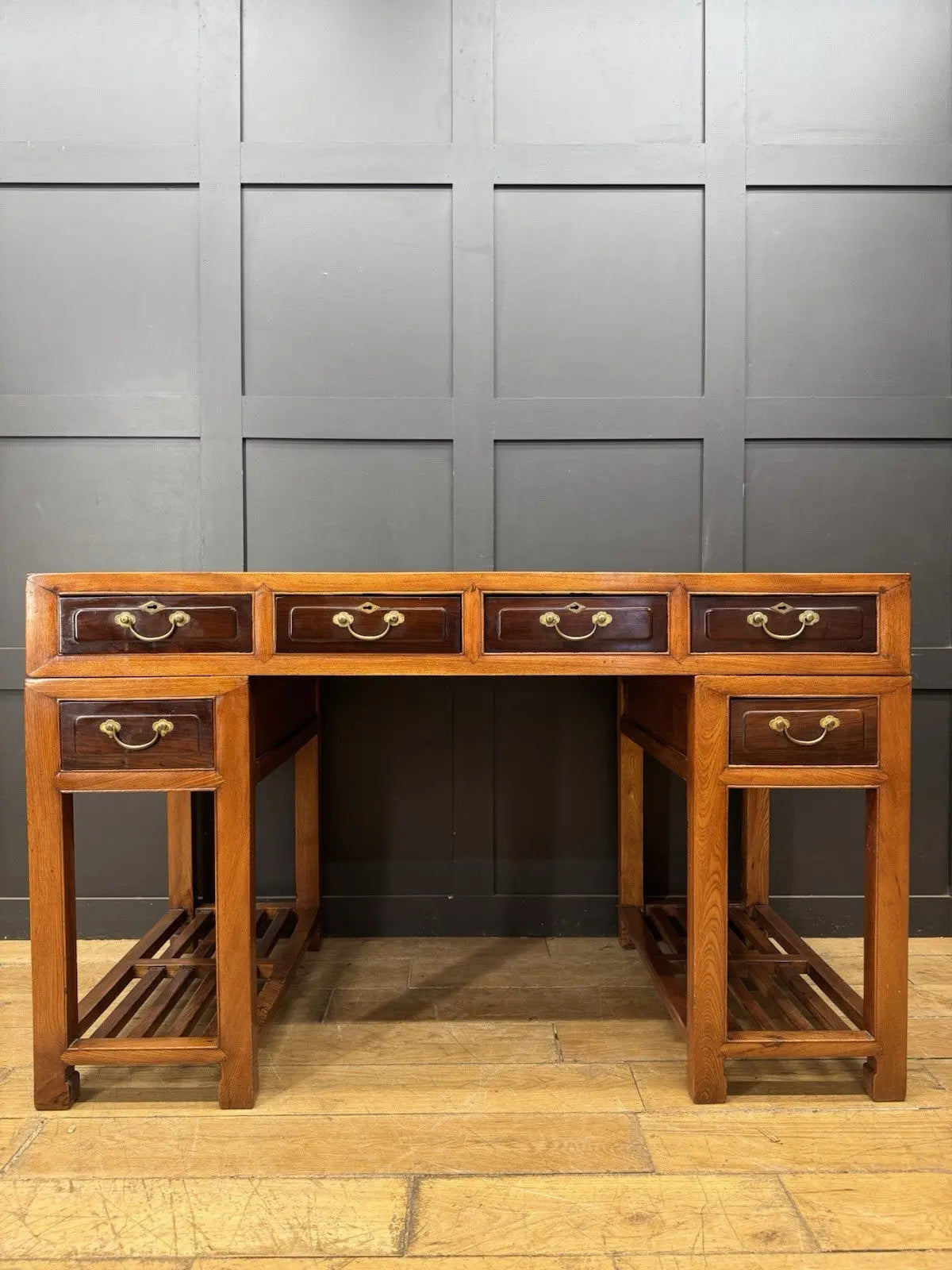 Antique Chinese hardwood writing desk, rich brown finish, elegant traditional pedestal design.