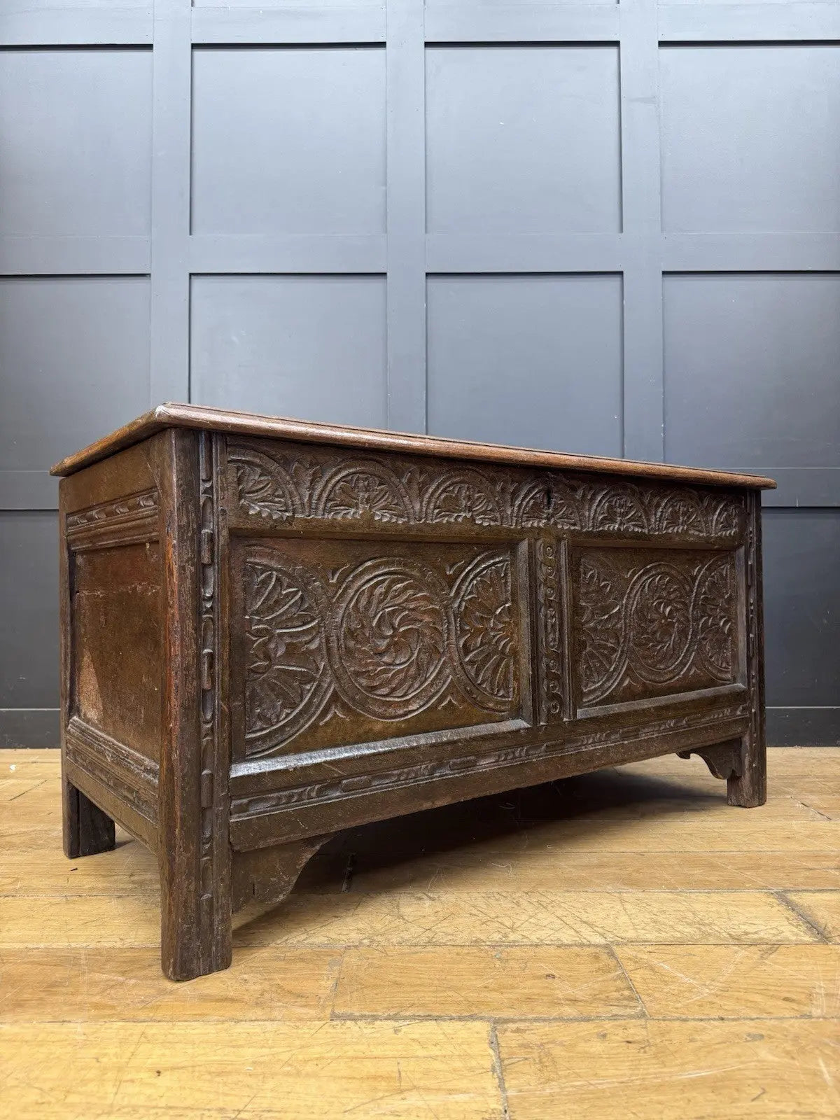Antique oak hope chest brown with intricate floral carvings and spacious interior.