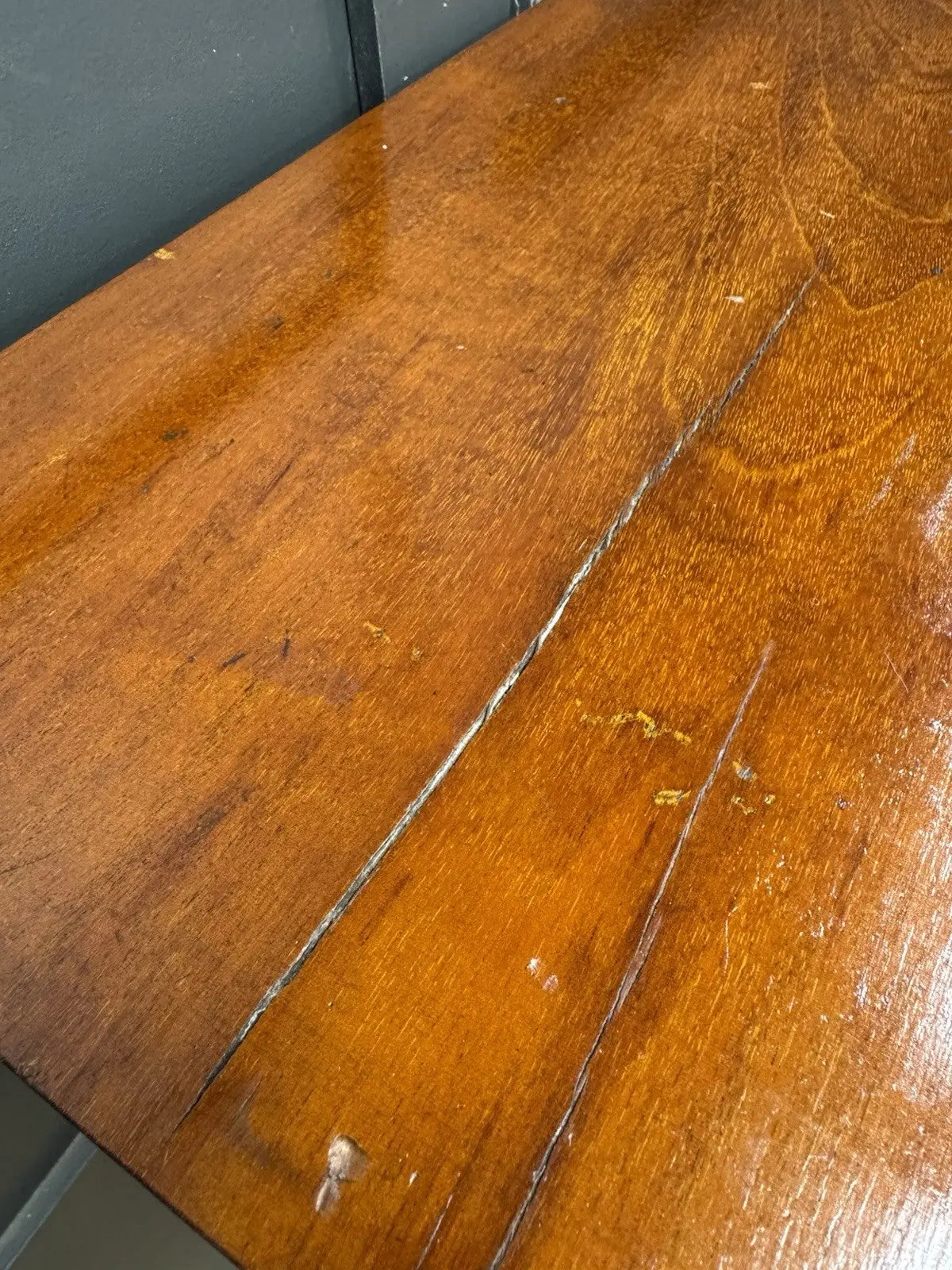 Antique brown mahogany chest of drawers with rounded corners and wooden knob handles.