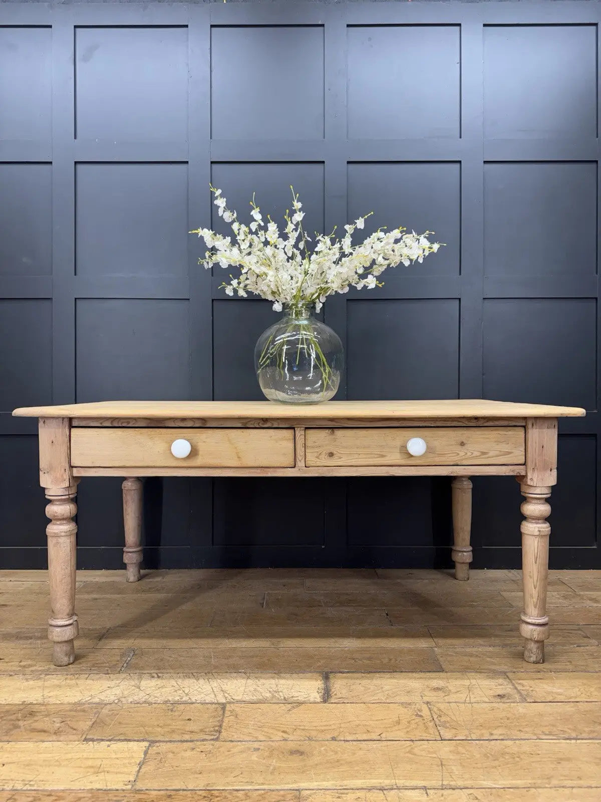 Victorian pine farmhouse dining table brown solid plank top with two drawers and ceramic knobs.