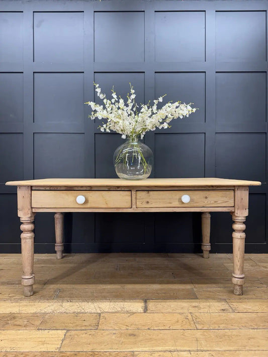 Victorian pine farmhouse dining table brown solid plank top with two drawers and ceramic knobs.