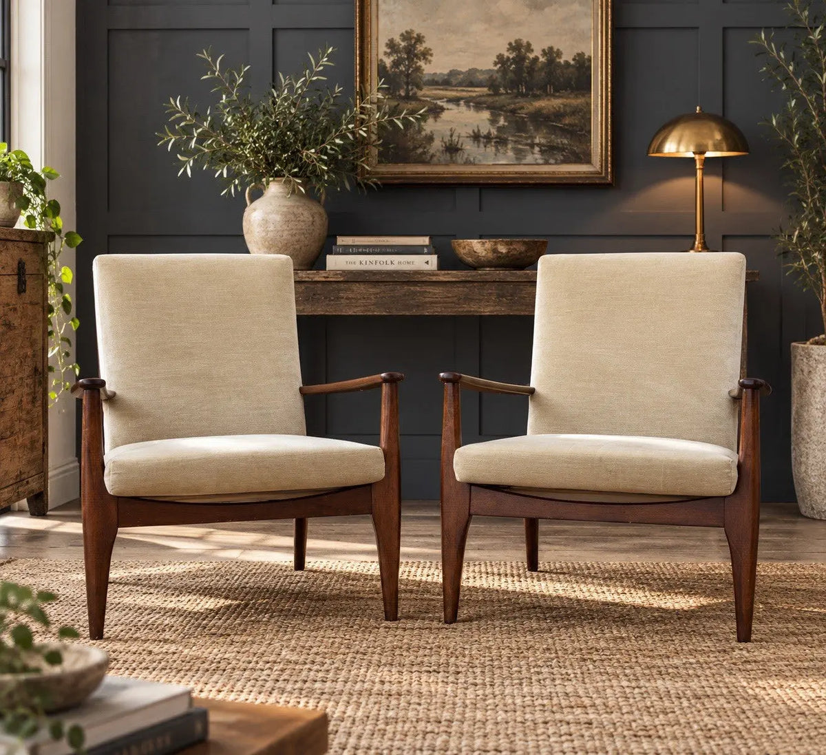 Parker Knoll cream armchairs with sculpted wooden arms and tapered legs, vintage mid-century design.