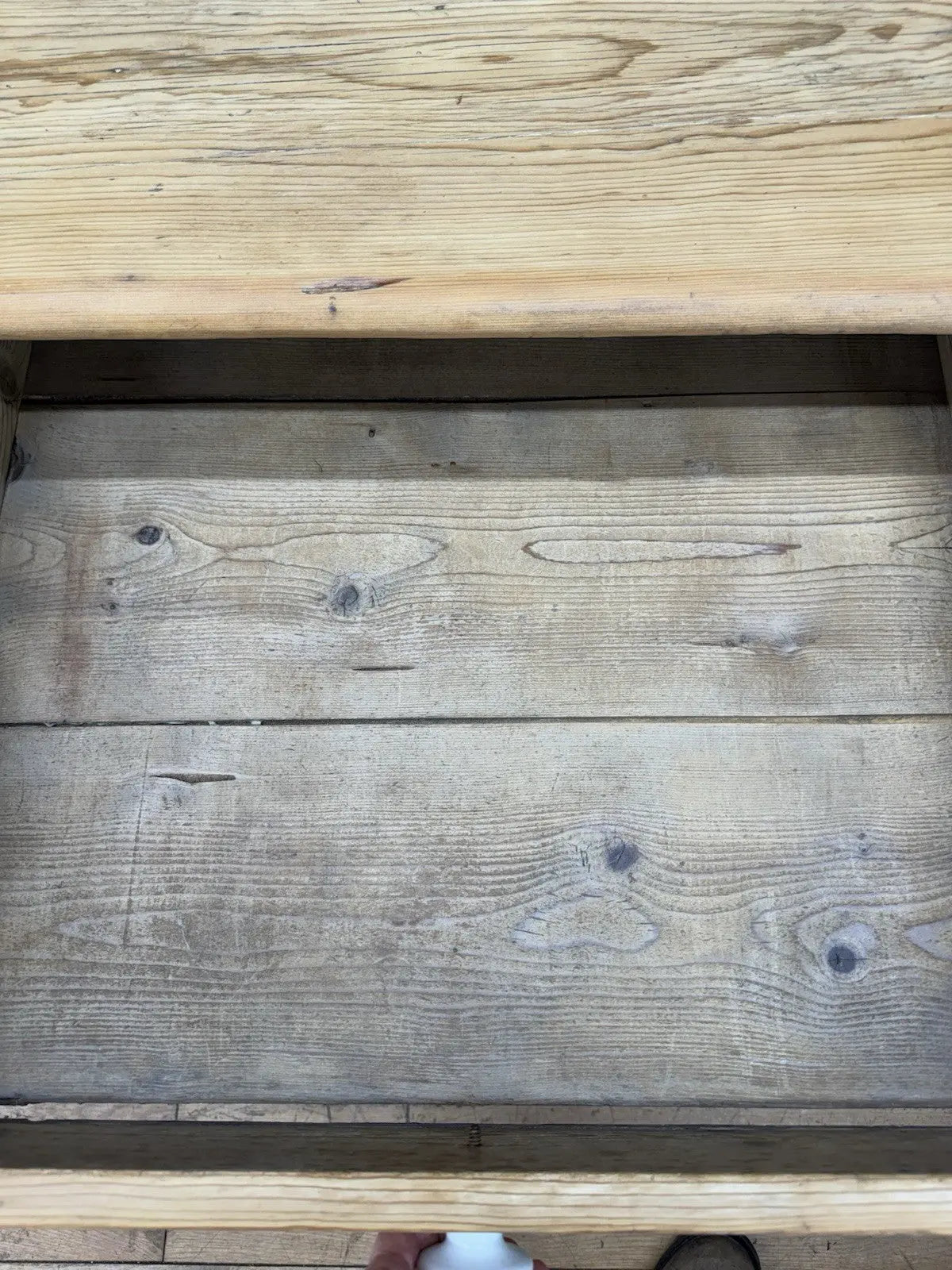 Victorian pine farmhouse dining table brown solid plank top with two drawers and ceramic knobs.