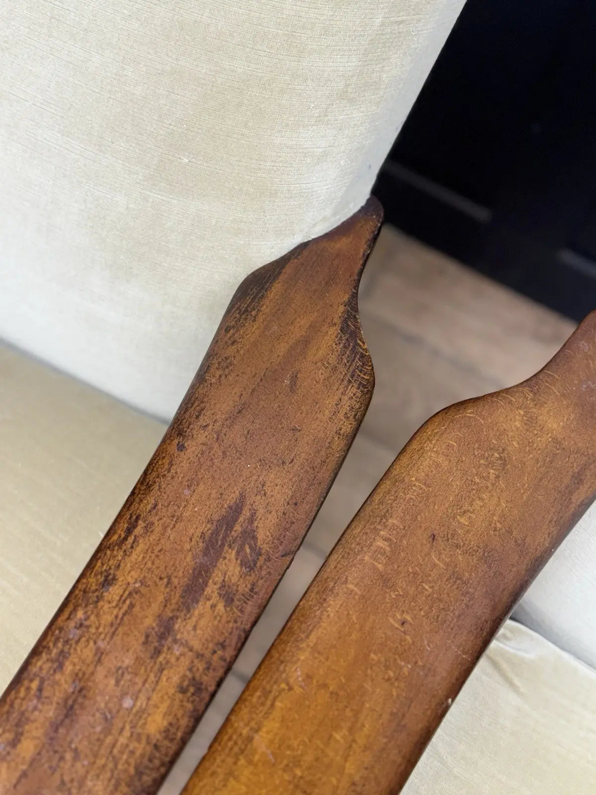 Parker Knoll cream armchairs with sculpted wooden arms and tapered legs, vintage mid-century design.