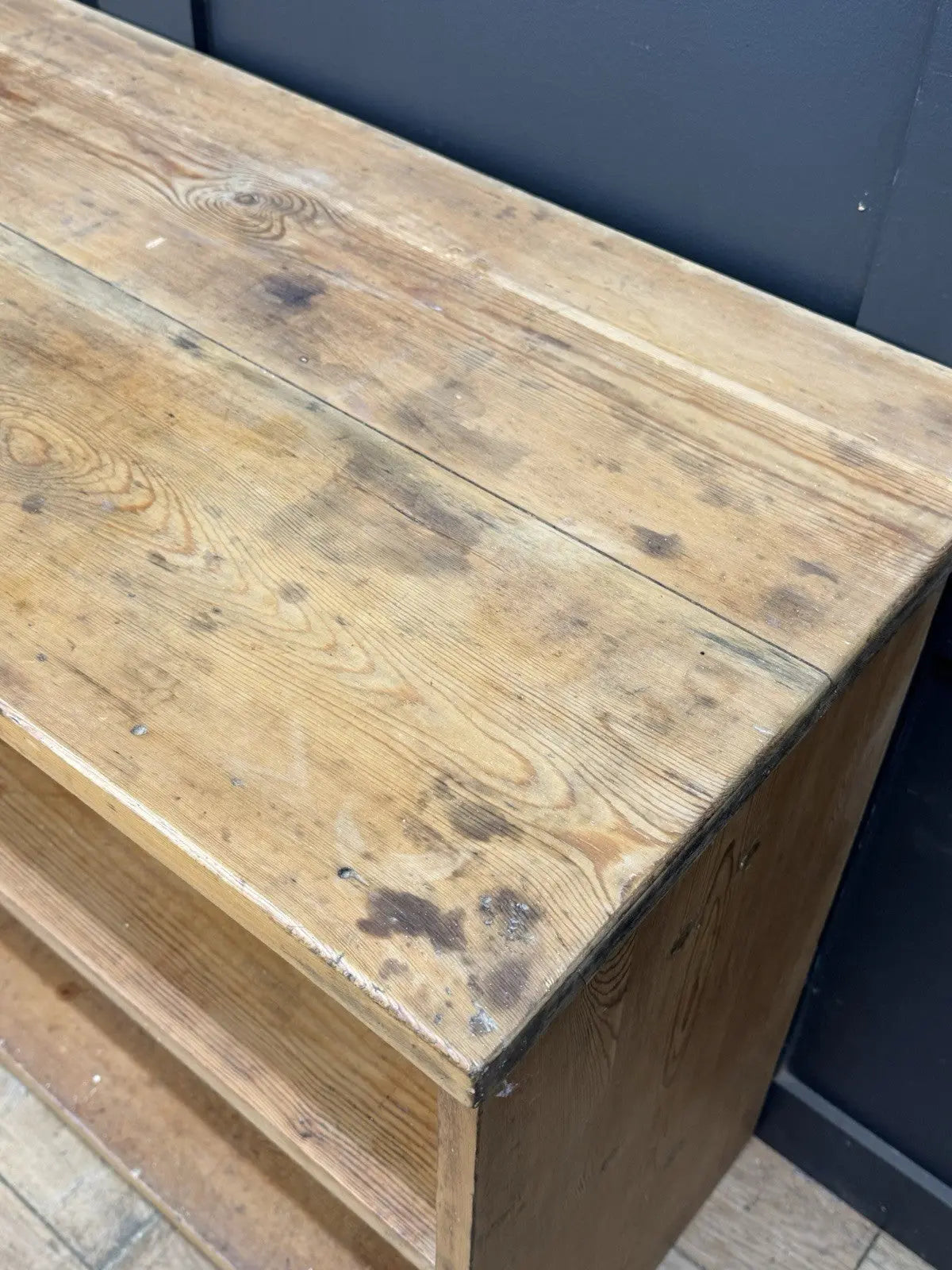 Vintage pine bookcase with warm, aged finish and two open shelves.